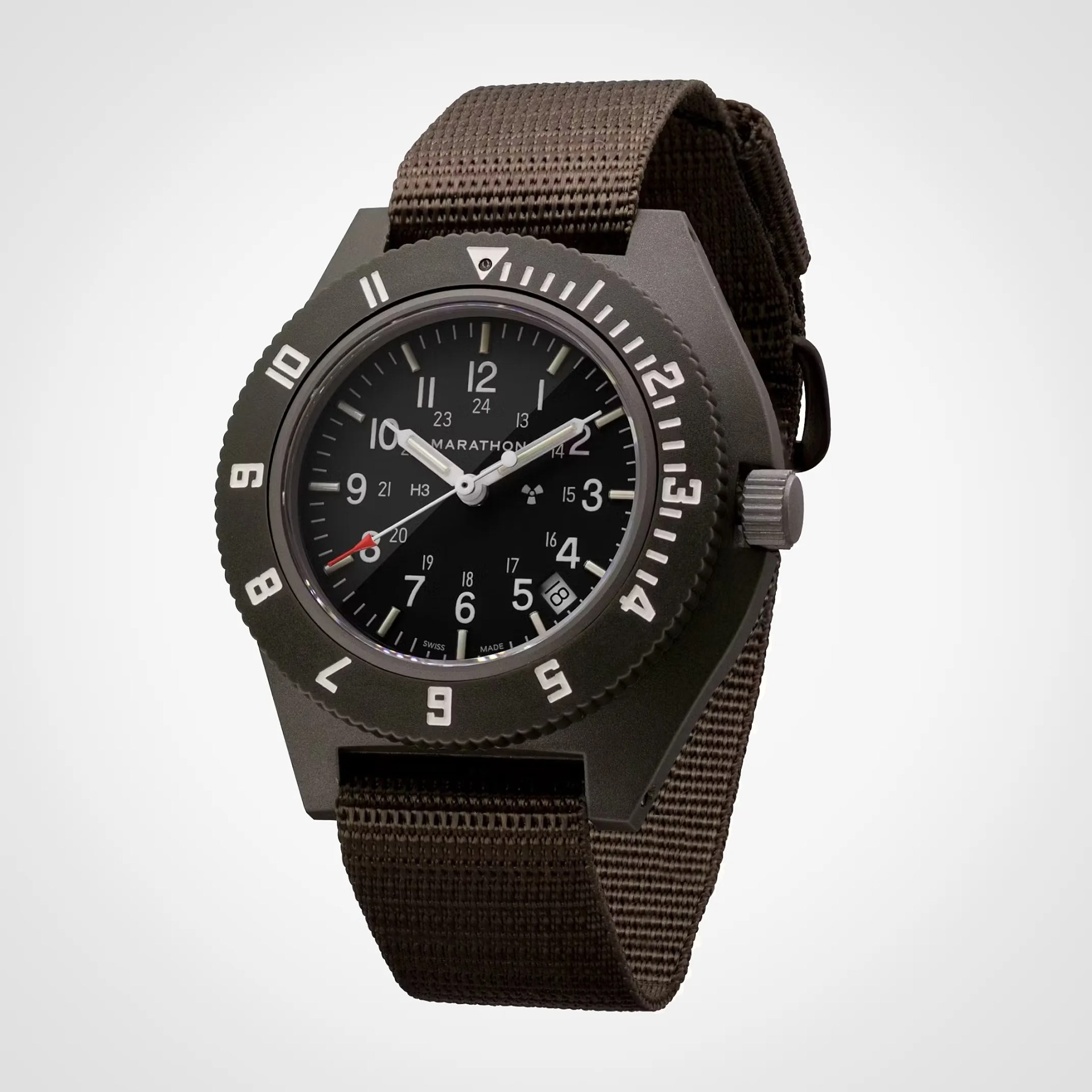 Black Marathon wristwatch with white numerals, date window, and brown nylon strap.