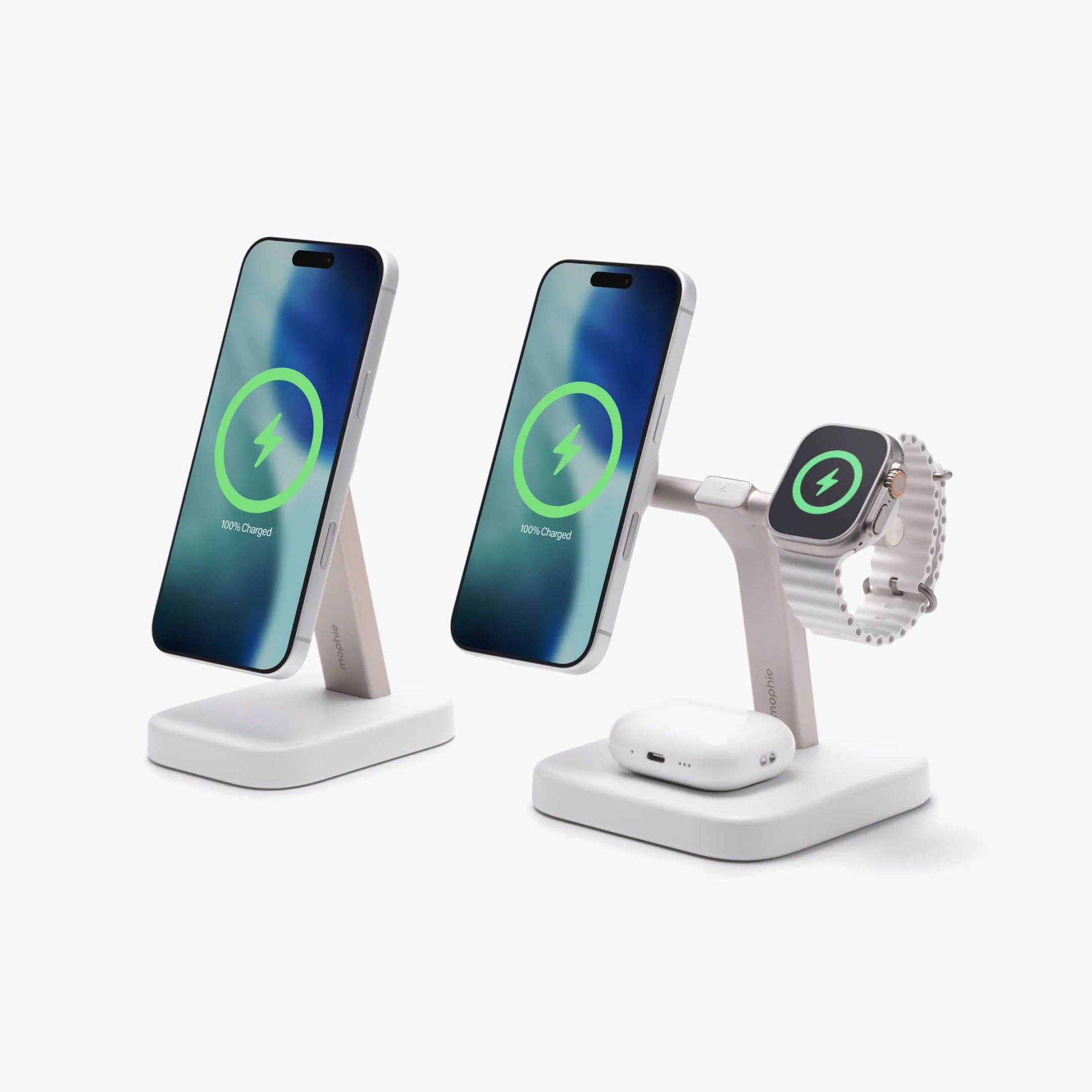 Two white wireless charging stands, one charging a smartphone, the other charging a smartphone, smartwatch, and wireless earbuds case.