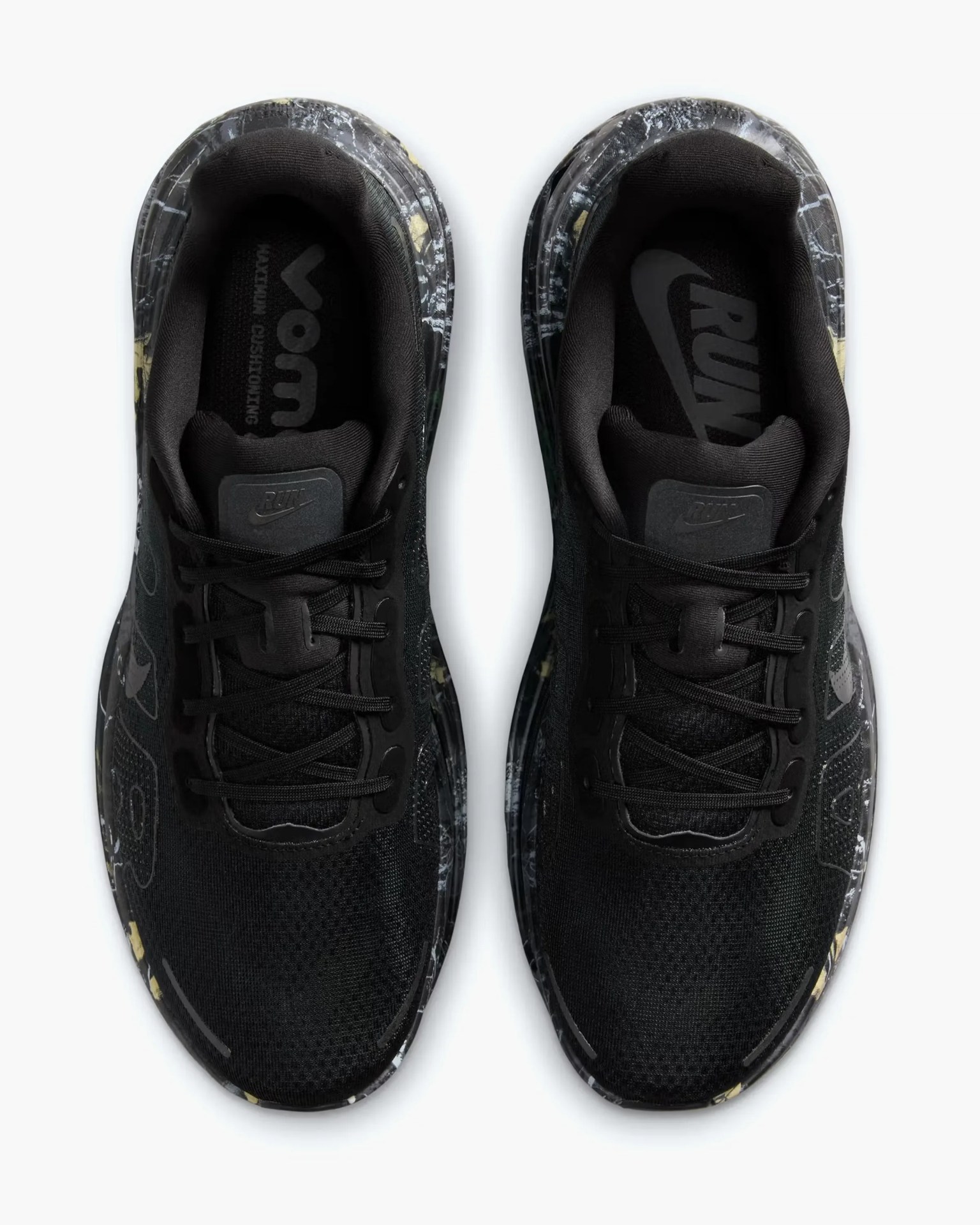 Pair of black Nike running shoes with patterned midsoles and black laces viewed from above.