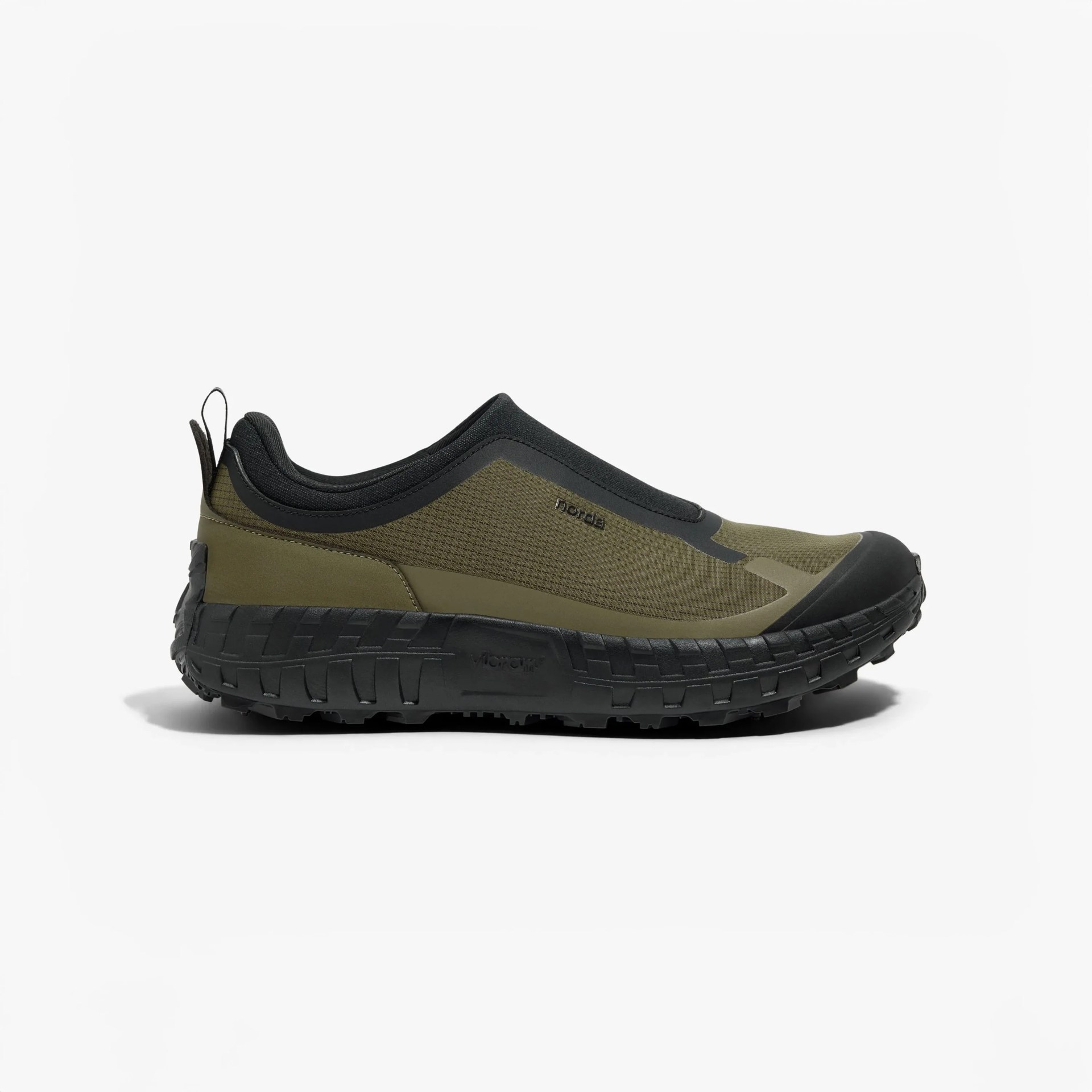 Olive green and black slip-on trail shoe with thick textured black sole and pull tabs at heel.