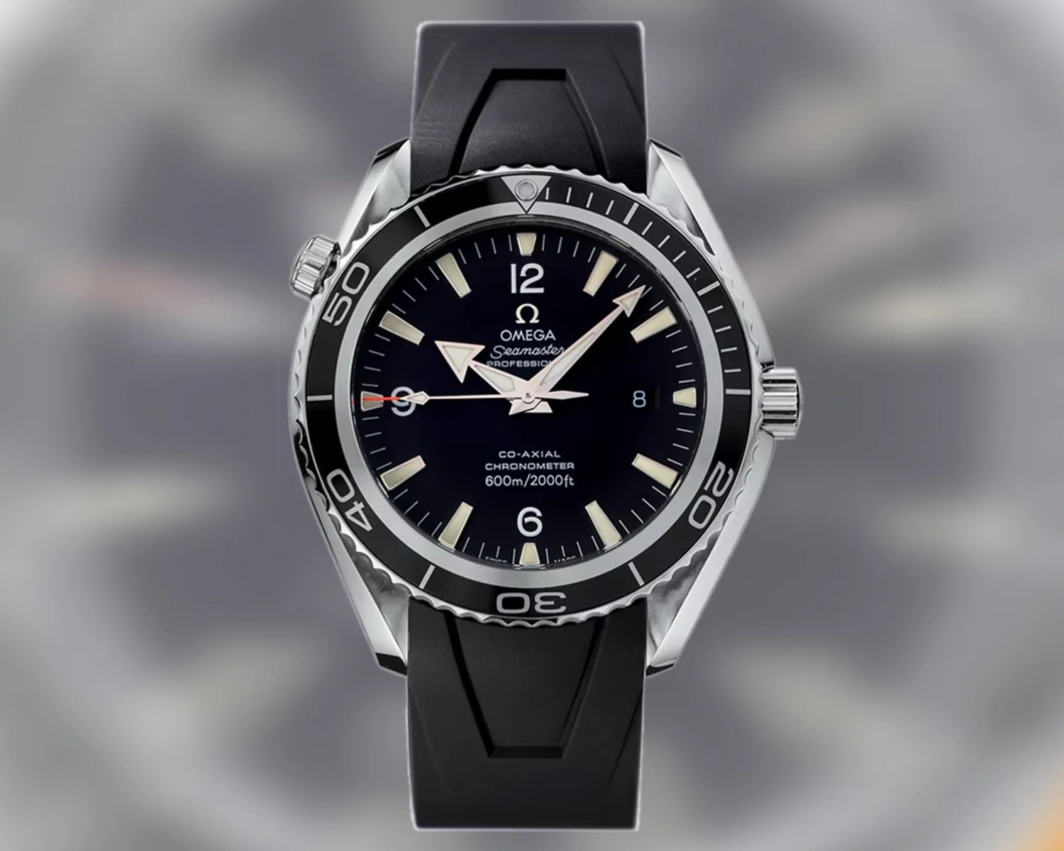Omega Seamaster Professional black dial dive watch with stainless steel case and black rubber strap.
