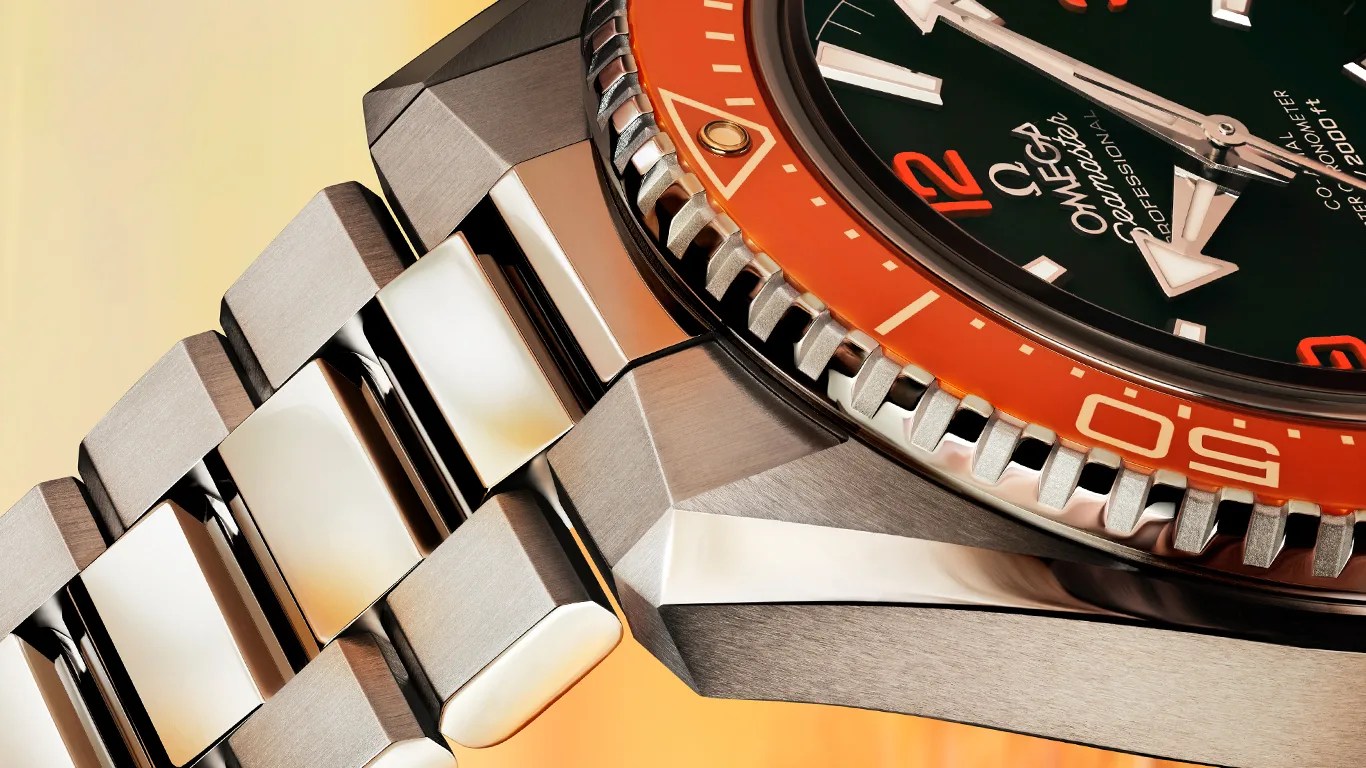Close-up of an Omega Seamaster Professional watch with a stainless steel bracelet and orange bezel.