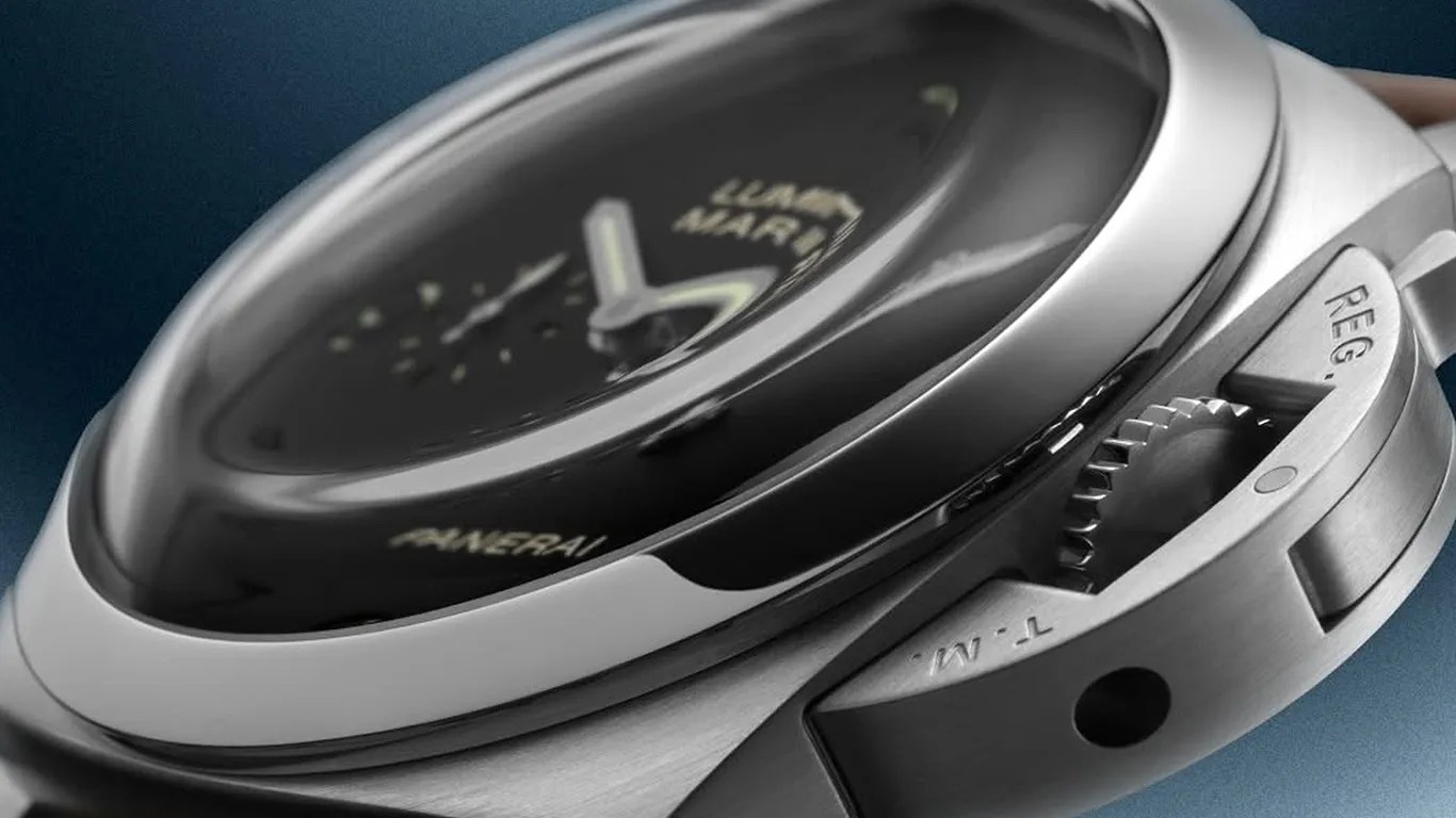 Close-up of a Panerai Luminor Marina watch with a domed crystal and brushed stainless steel case showing the crown guard.