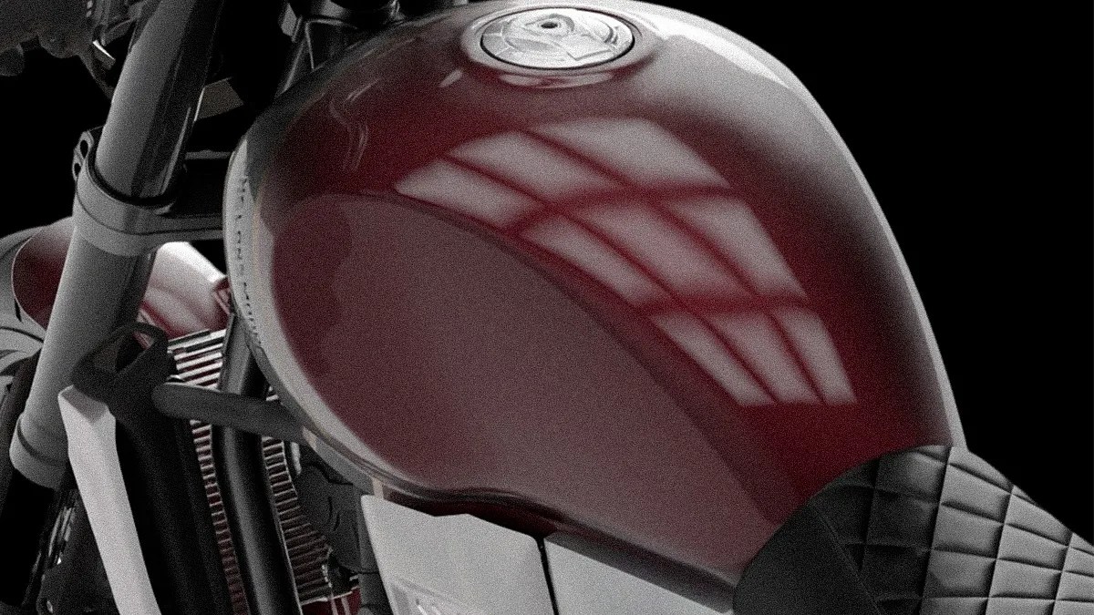 Glossy dark red motorcycle fuel tank with a silver cap and part of a black quilted seat.