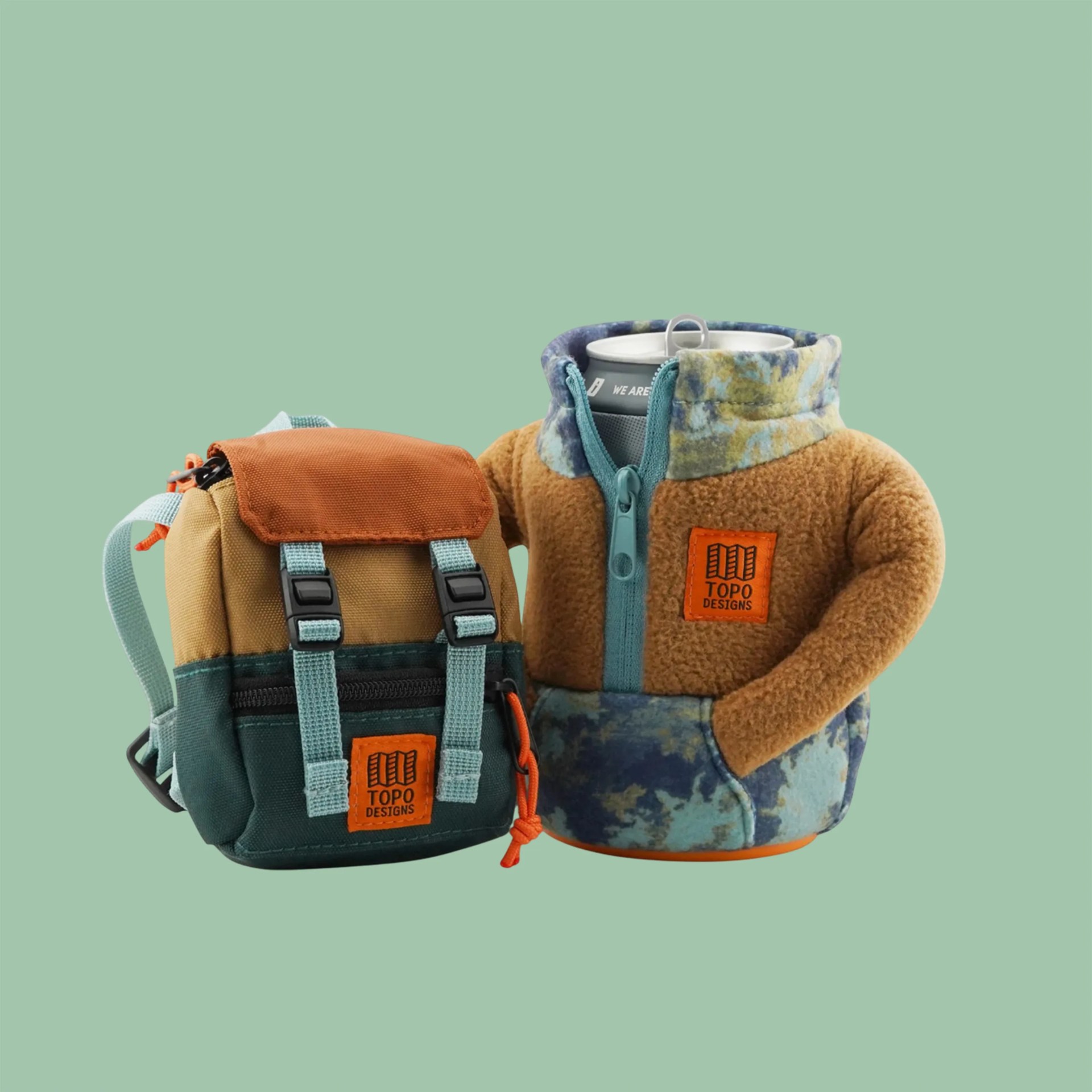 Small multicolor canvas backpack and a can cooler shaped like a fleece jacket with a zipper and pockets, both with Topo Designs logos.