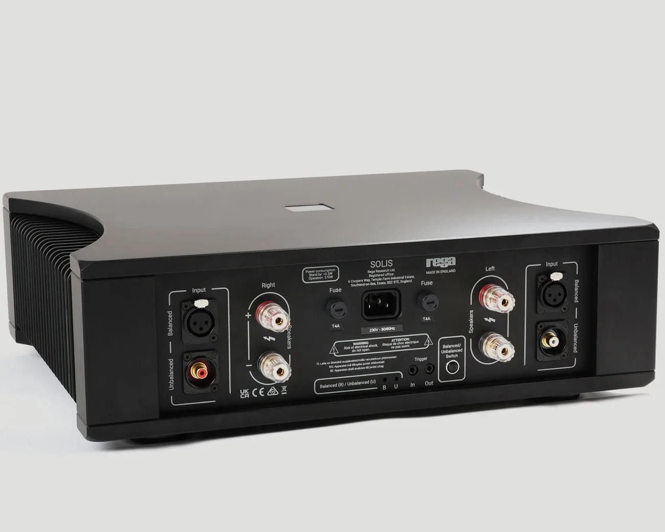 Black Rega Solis audio amplifier with multiple input and speaker output ports on a white background.
