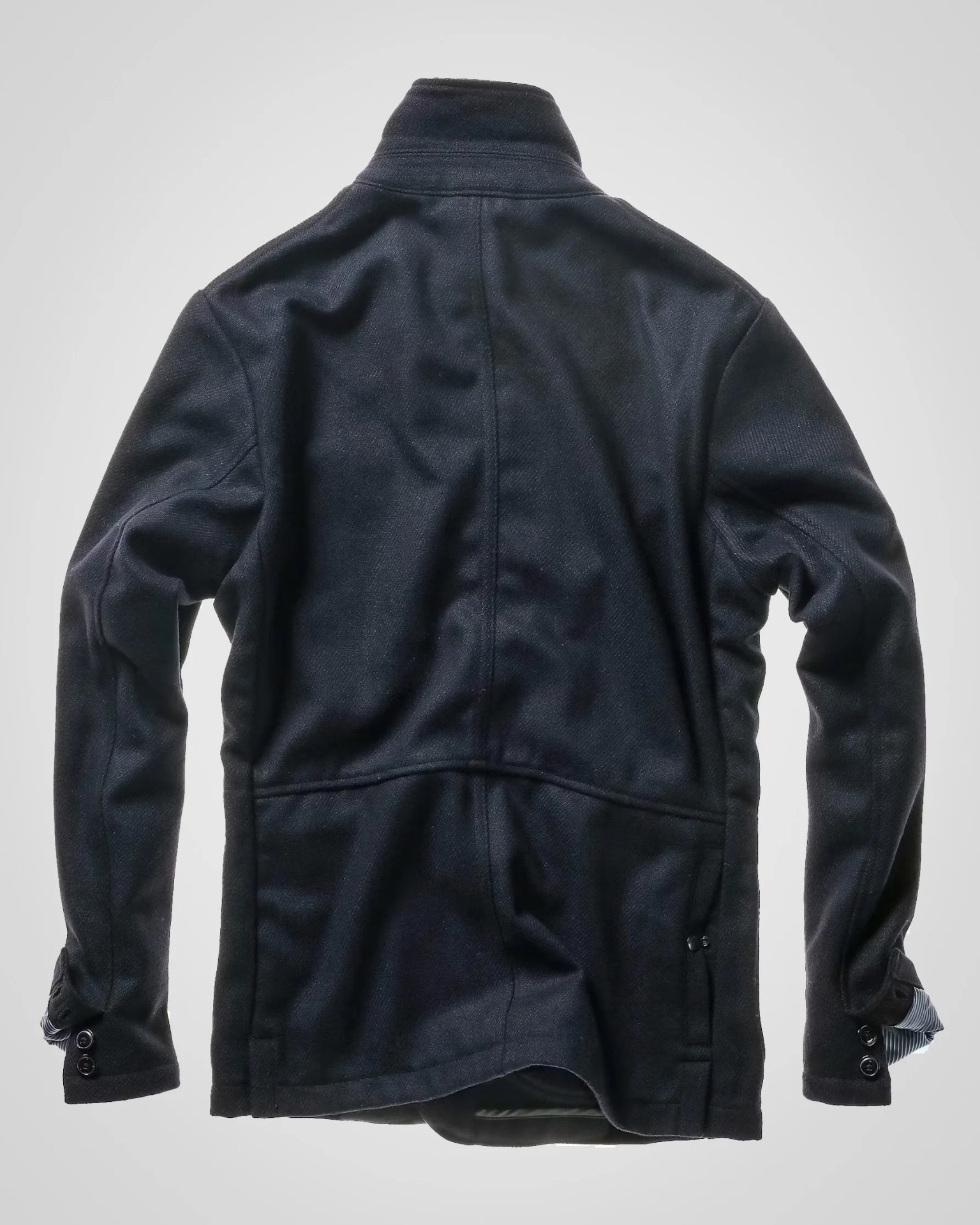 Black wool jacket with buttoned cuffs shown from the back on a gray background.