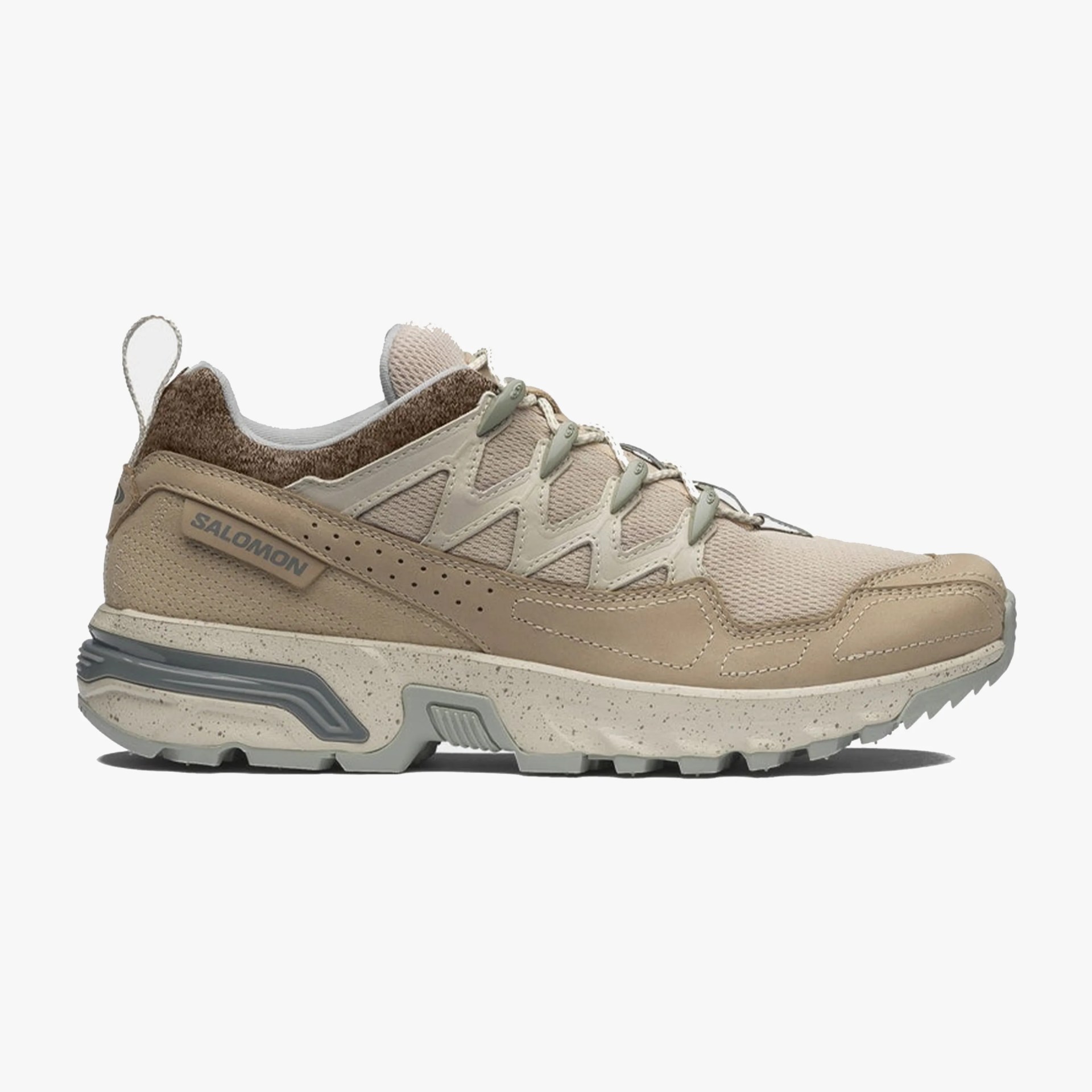 Beige and light brown Salomon sneaker with mesh and suede upper, speckled midsole, and rugged outsole.