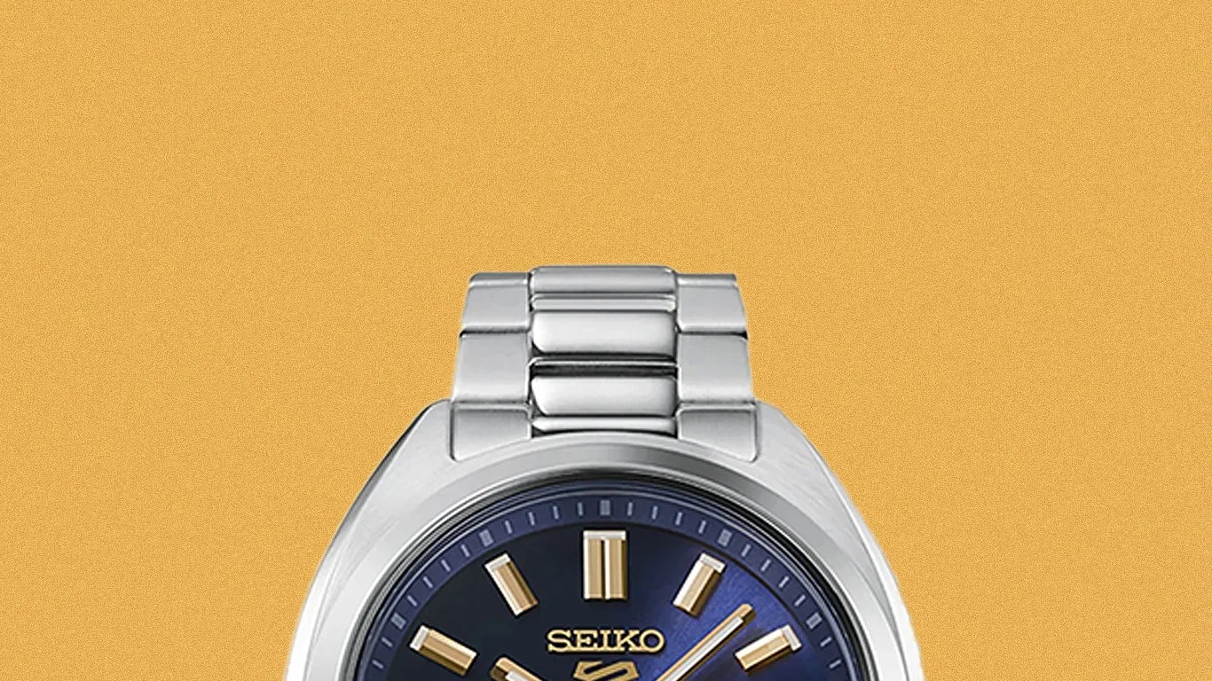 Silver stainless steel Seiko wristwatch with blue dial and gold-tone hour markers and hands.
