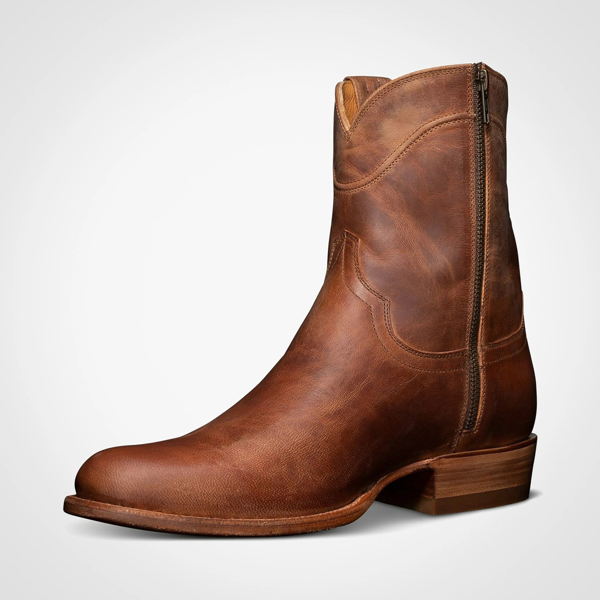 Brown leather ankle boot with side zipper and low stacked wooden heel on a white background.