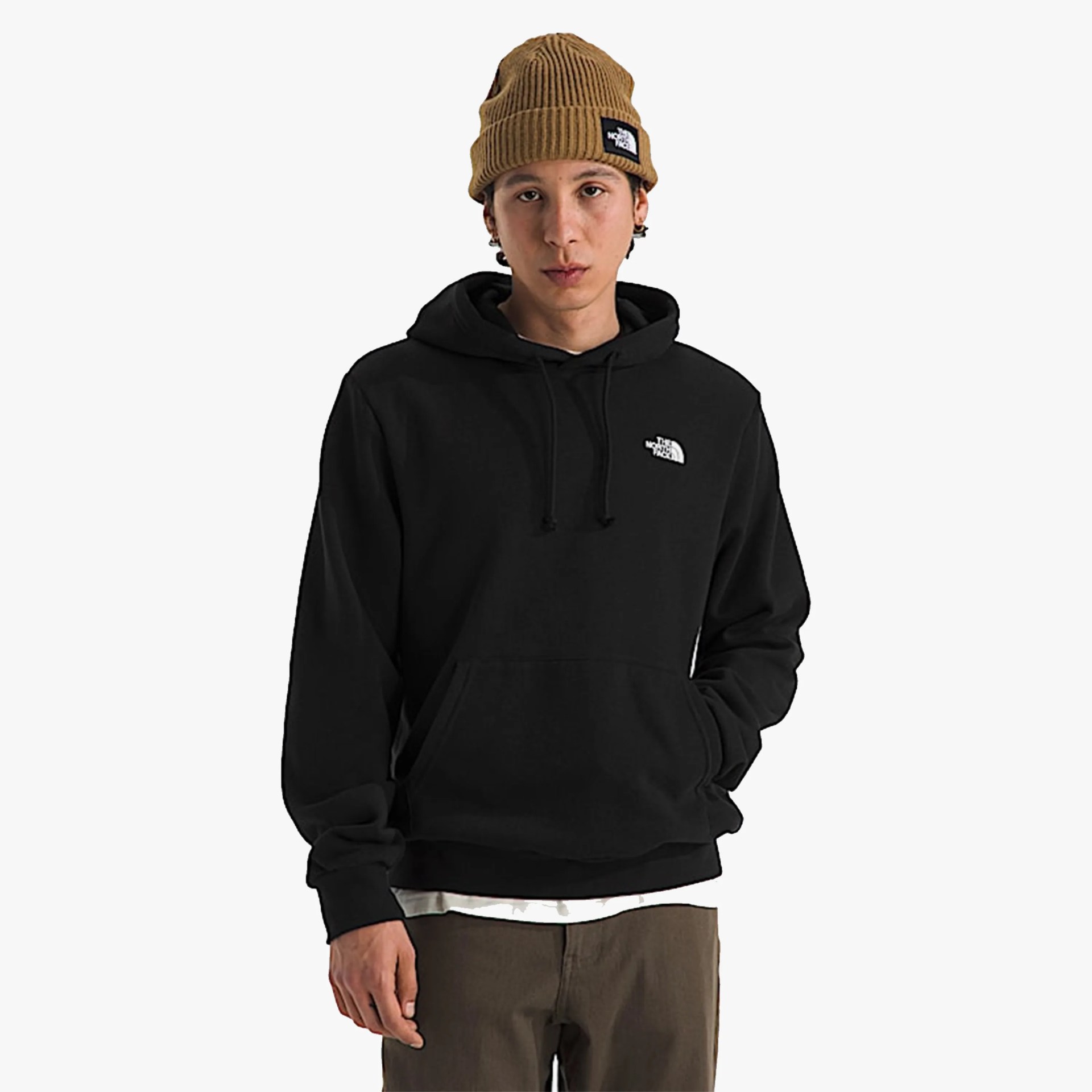 Black pullover hoodie with front pocket and white logo on chest worn by a person with a brown knit beanie.