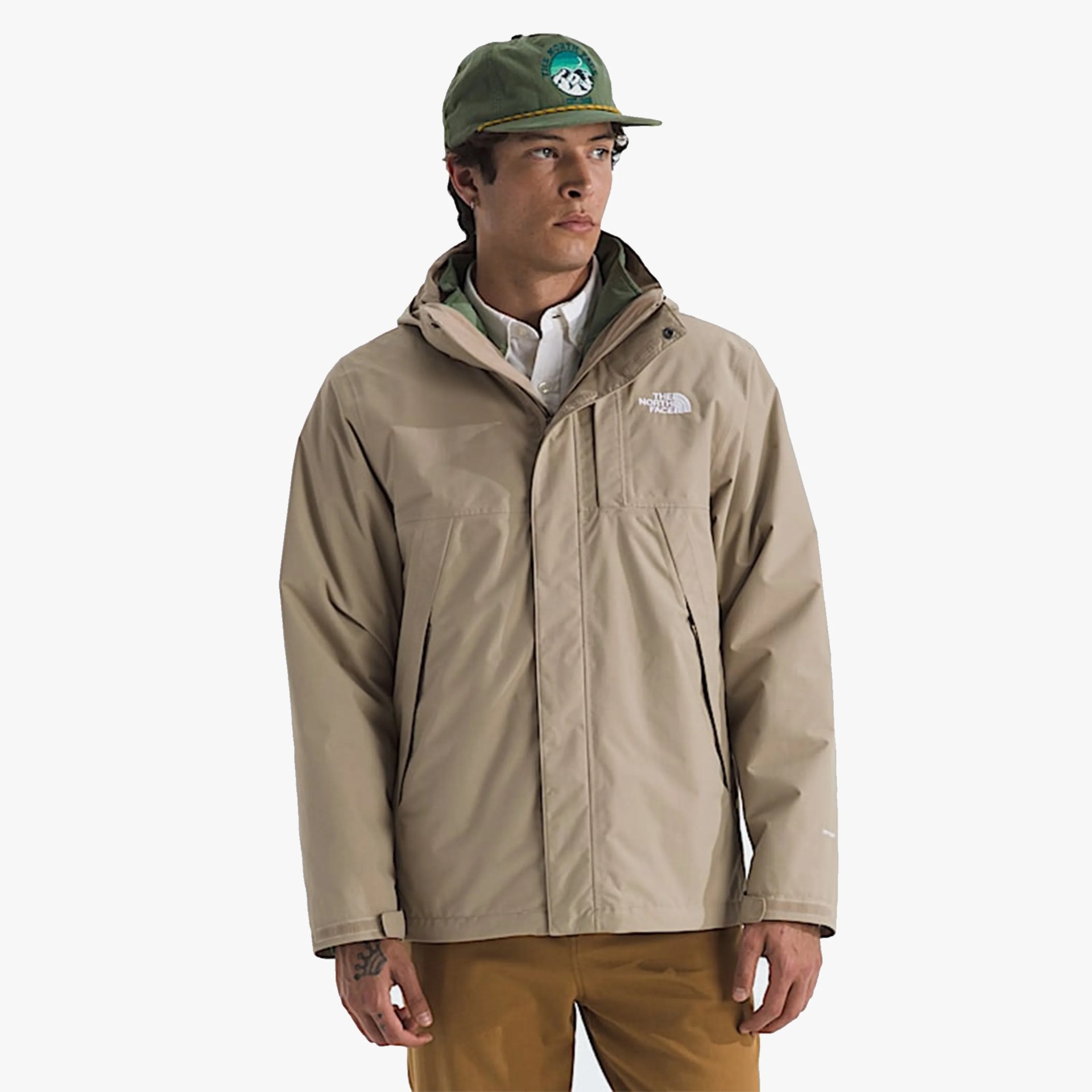 Beige The North Face waterproof jacket with hood worn over a white shirt.