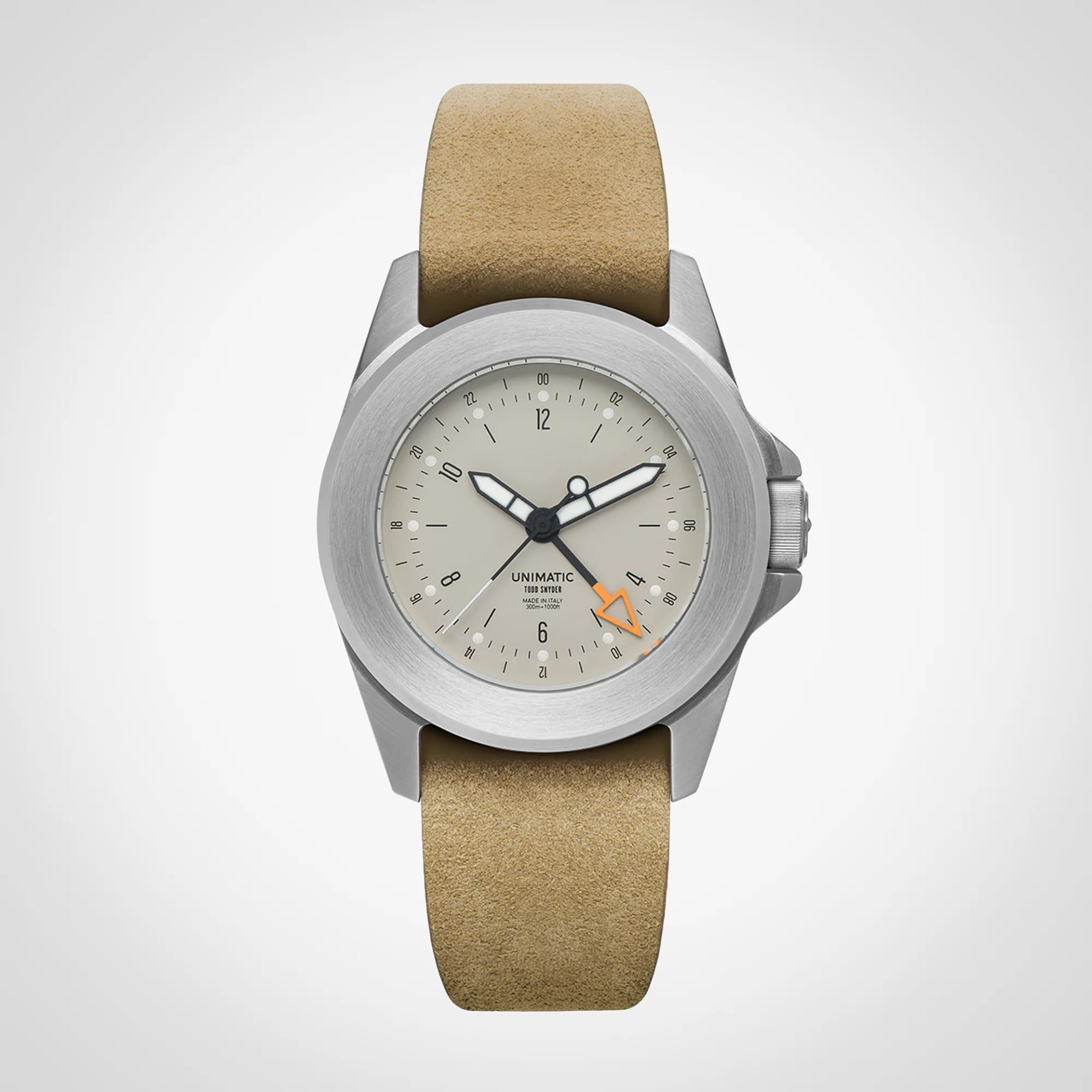 Silver Unimatic wristwatch with beige suede strap and cream dial featuring black and orange hands.