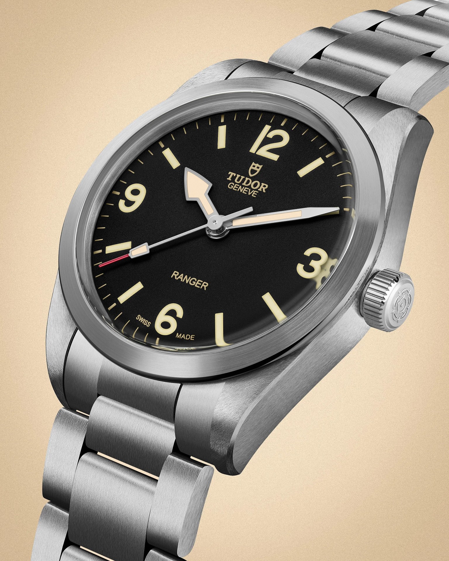 Stainless steel Tudor Ranger wristwatch with black dial, beige luminous hands and markers, and metal bracelet.
