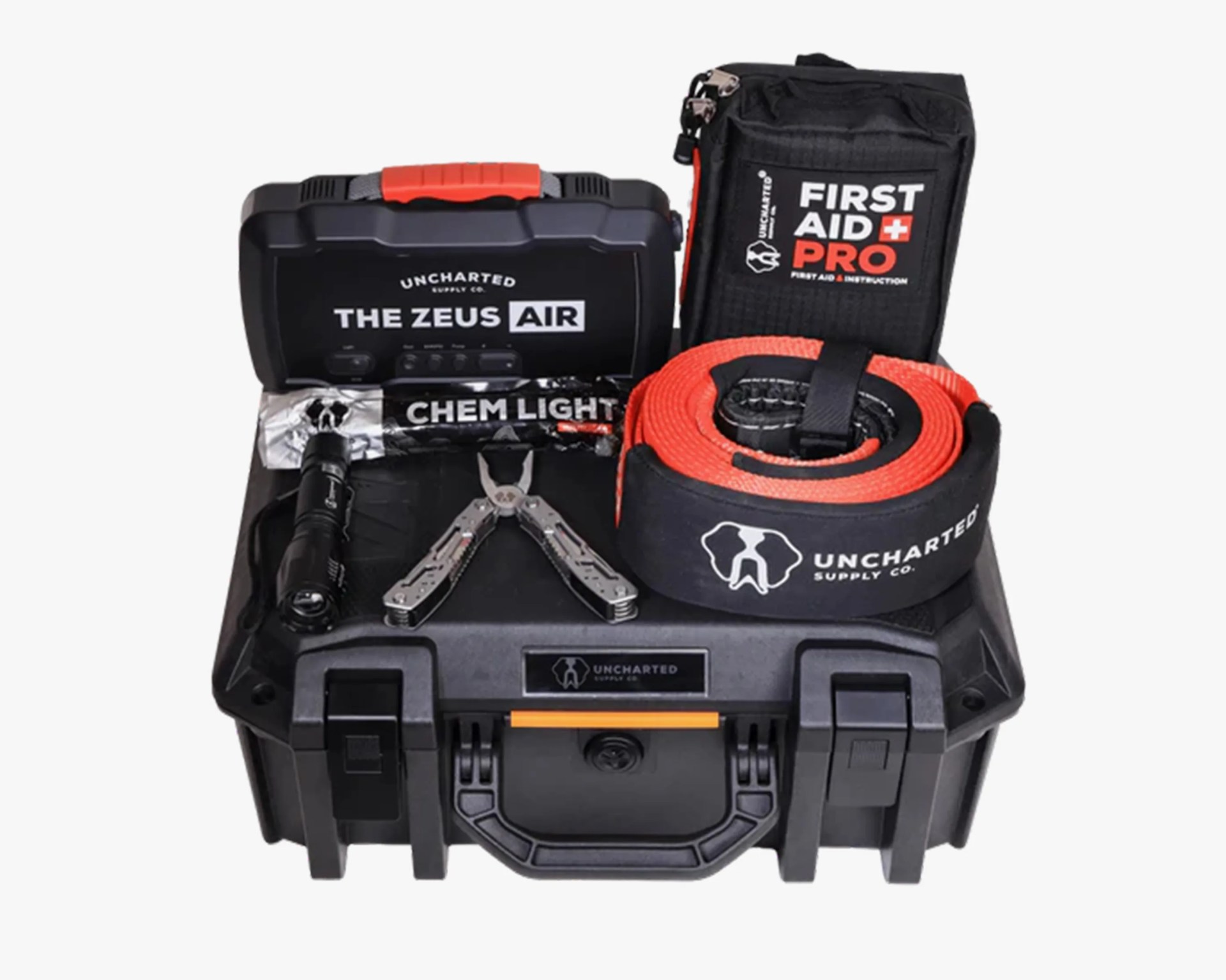 Black hard plastic survival kit case with orange handle, multi-tool, flashlight, chem light, first aid kit, and orange rescue strap.