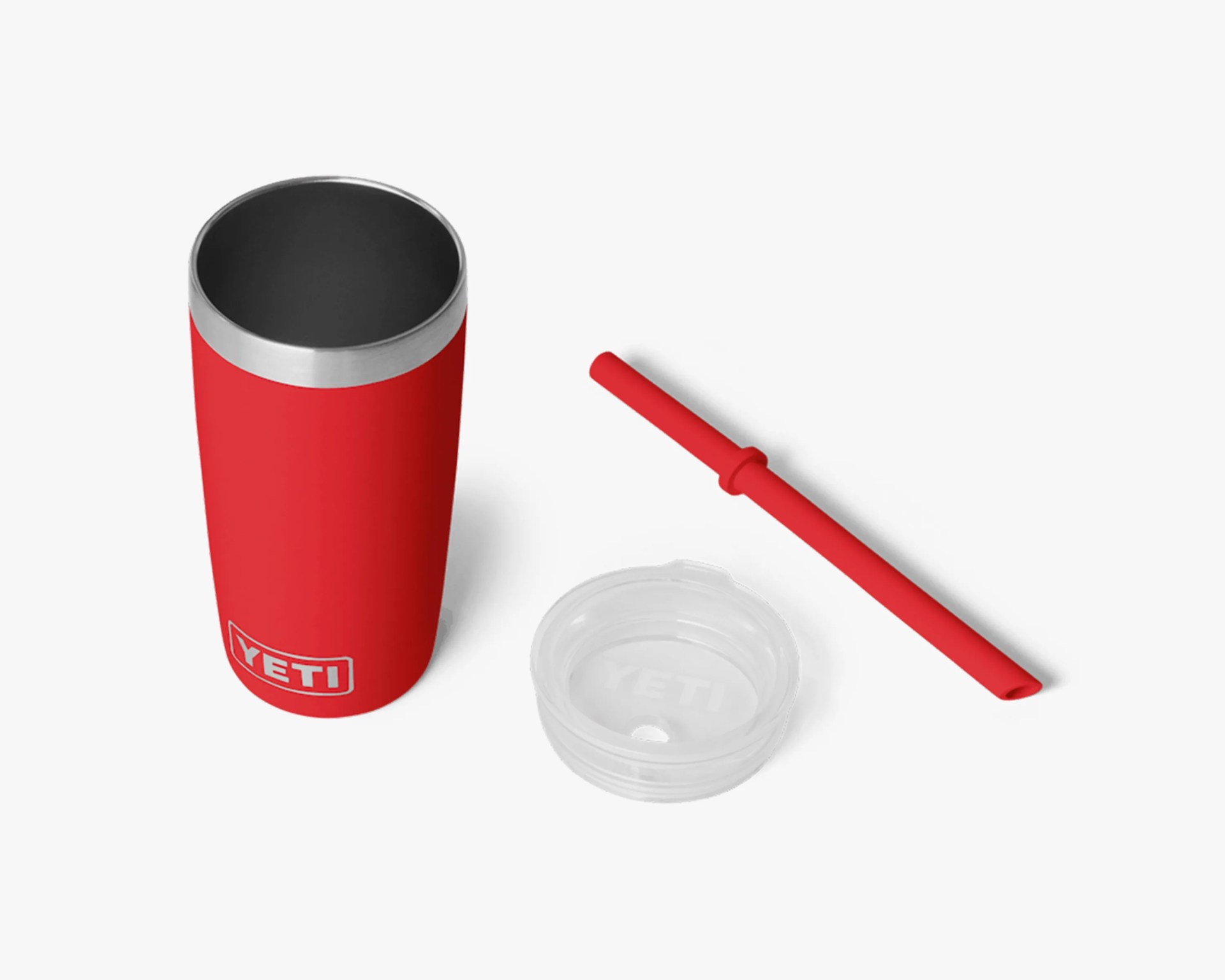 Red YETI tumbler with stainless steel rim, clear plastic lid, and red reusable straw on white background.