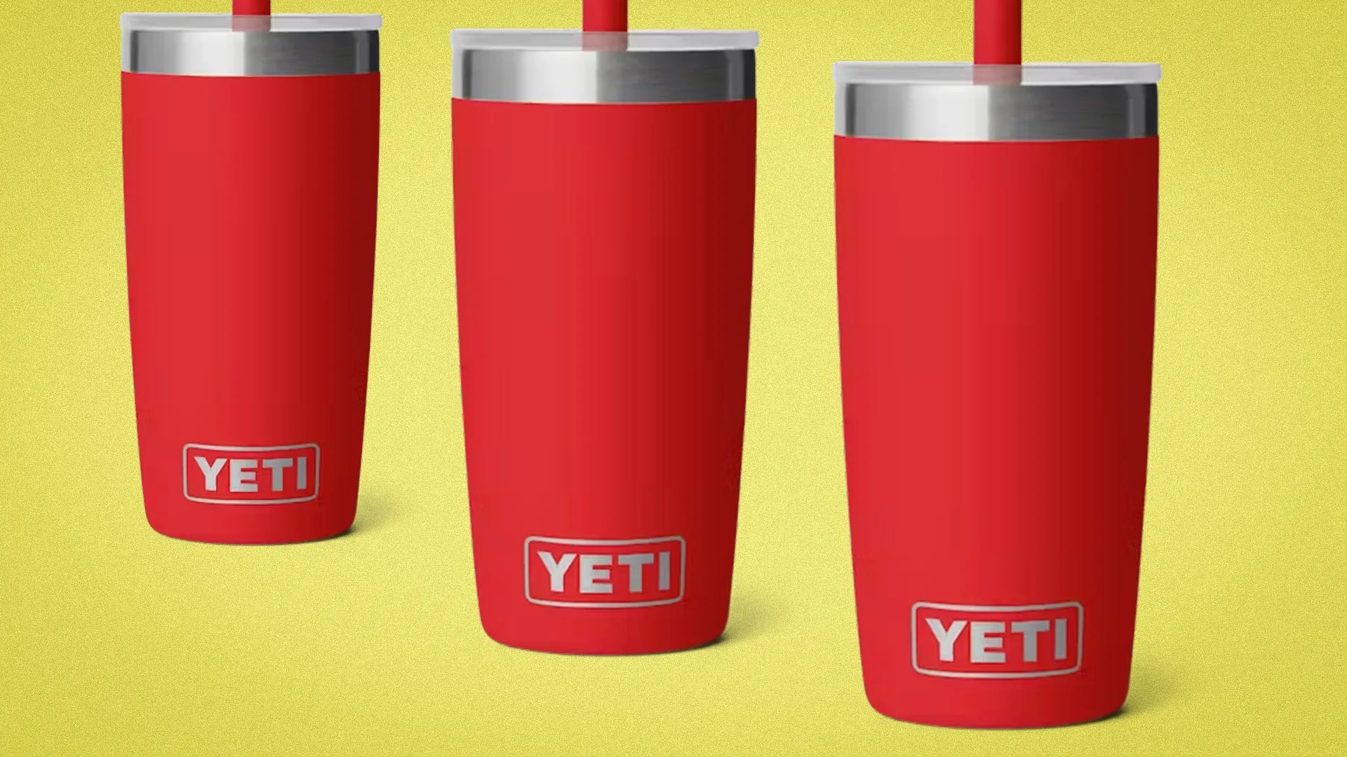 Three red YETI tumblers with silver lids and red straws on a yellow background.