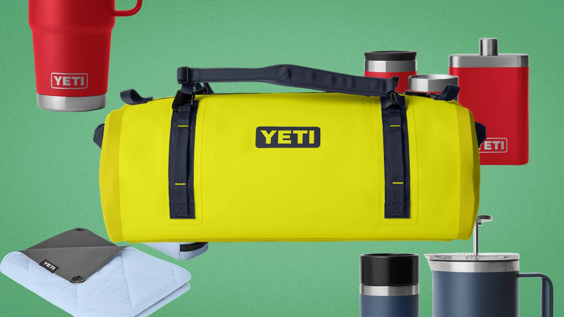 Yellow YETI duffel bag with black straps surrounded by red and blue YETI drinkware and a folded blanket on a green background.