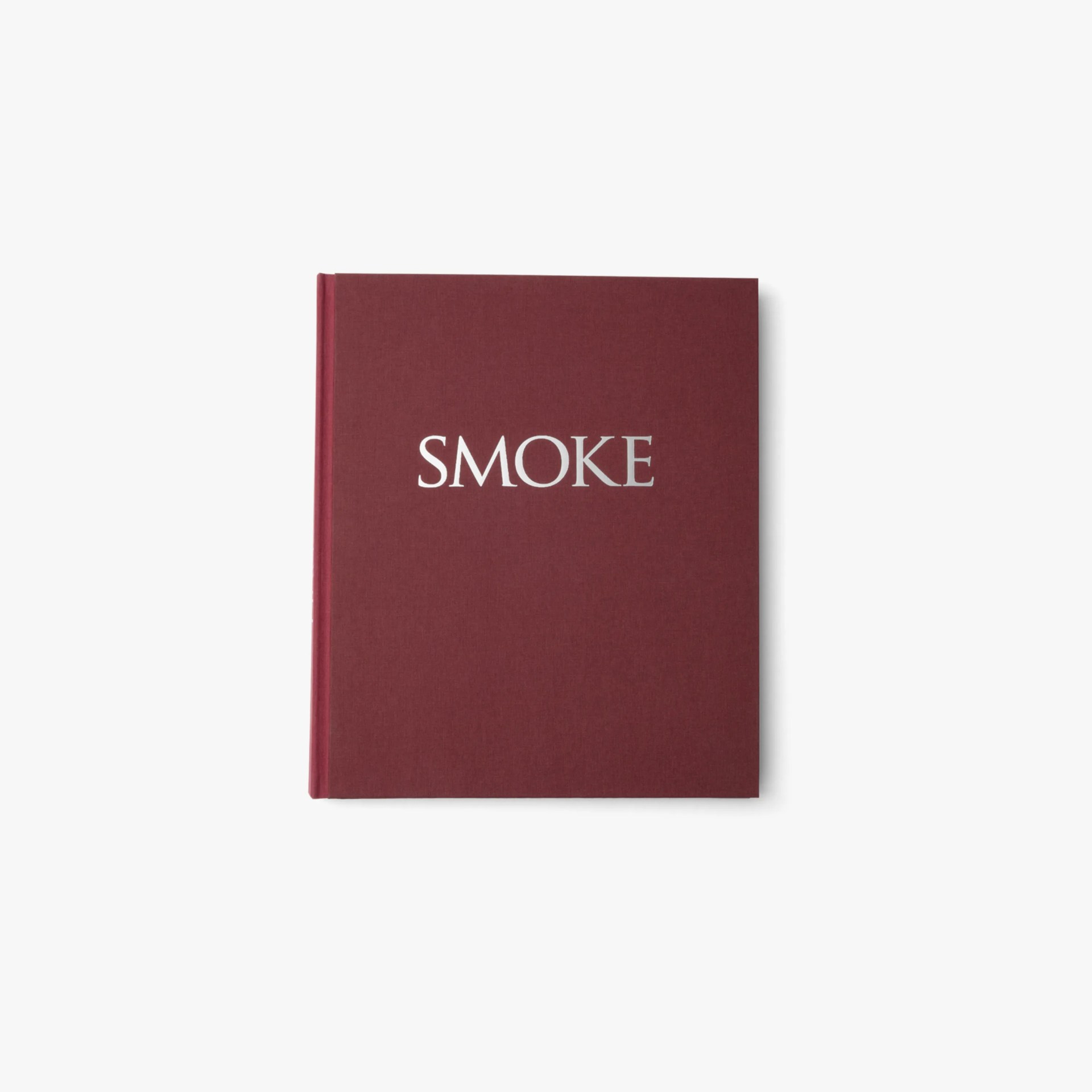 Maroon hardcover book with the word "SMOKE" in silver letters on the cover.