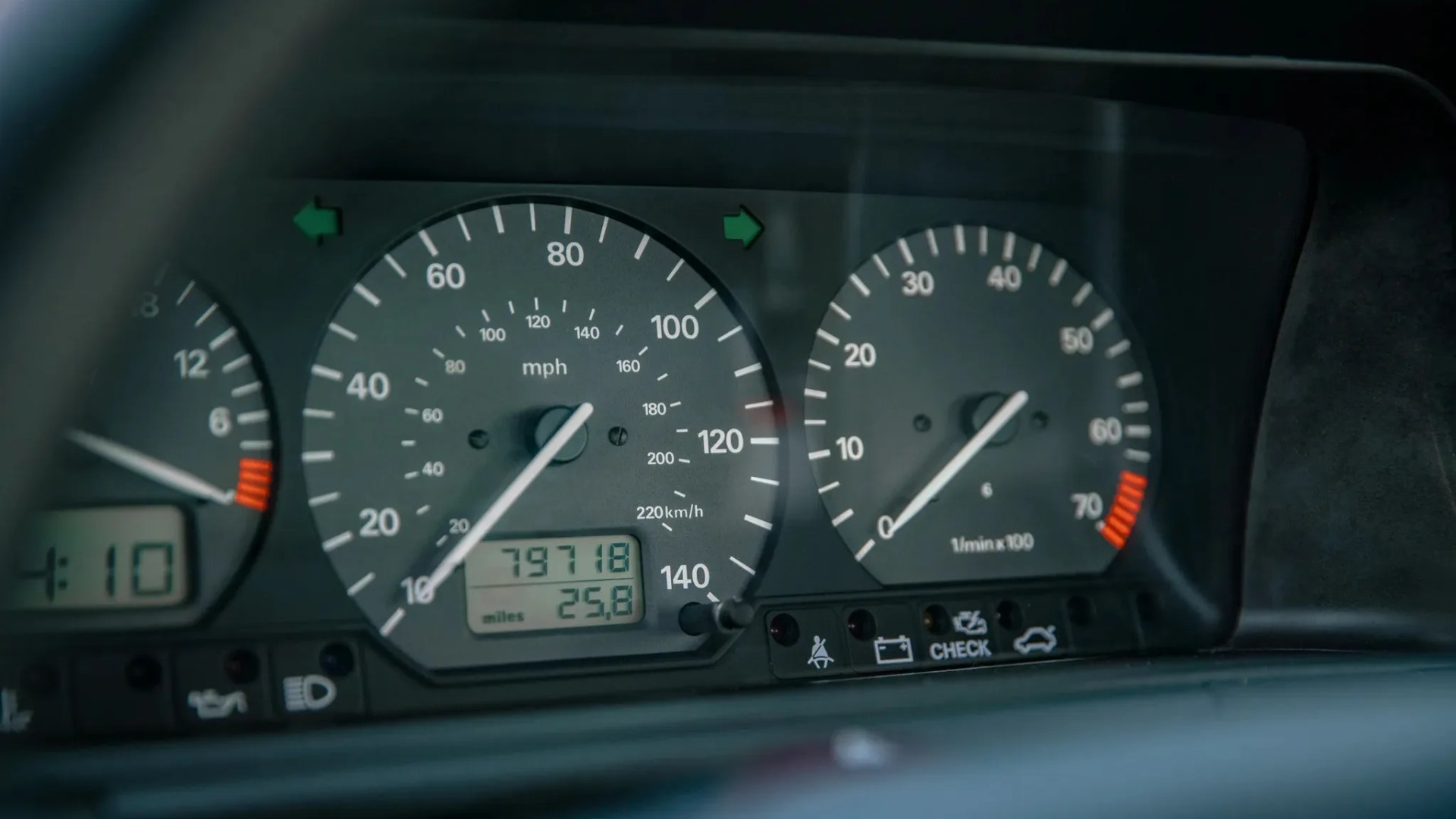 Car dashboard showing speedometer at 10 mph, tachometer near 50,000 rpm, and odometer reading 79,718 miles.