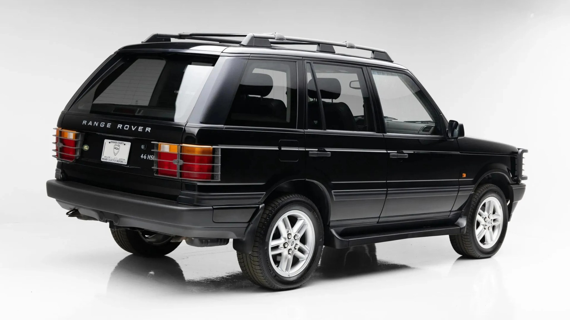 Black Range Rover 4.6 HSE SUV with roof rails and silver alloy wheels in a white studio.