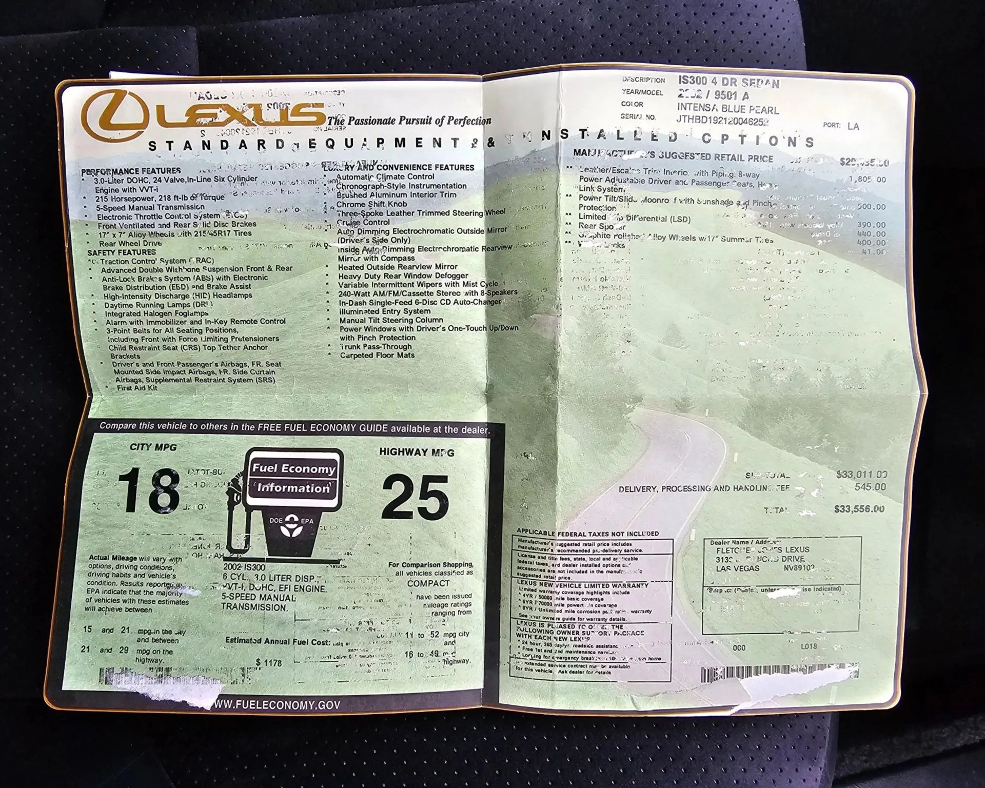 Open Lexus vehicle window sticker showing performance features, fuel economy (18 city, 25 highway MPG), and pricing details.
