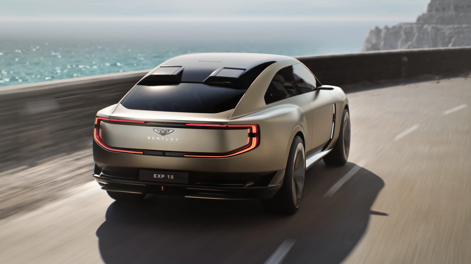 Matte beige Bentley EXP 15 electric coupe with sleek rear lights driving on coastal road.