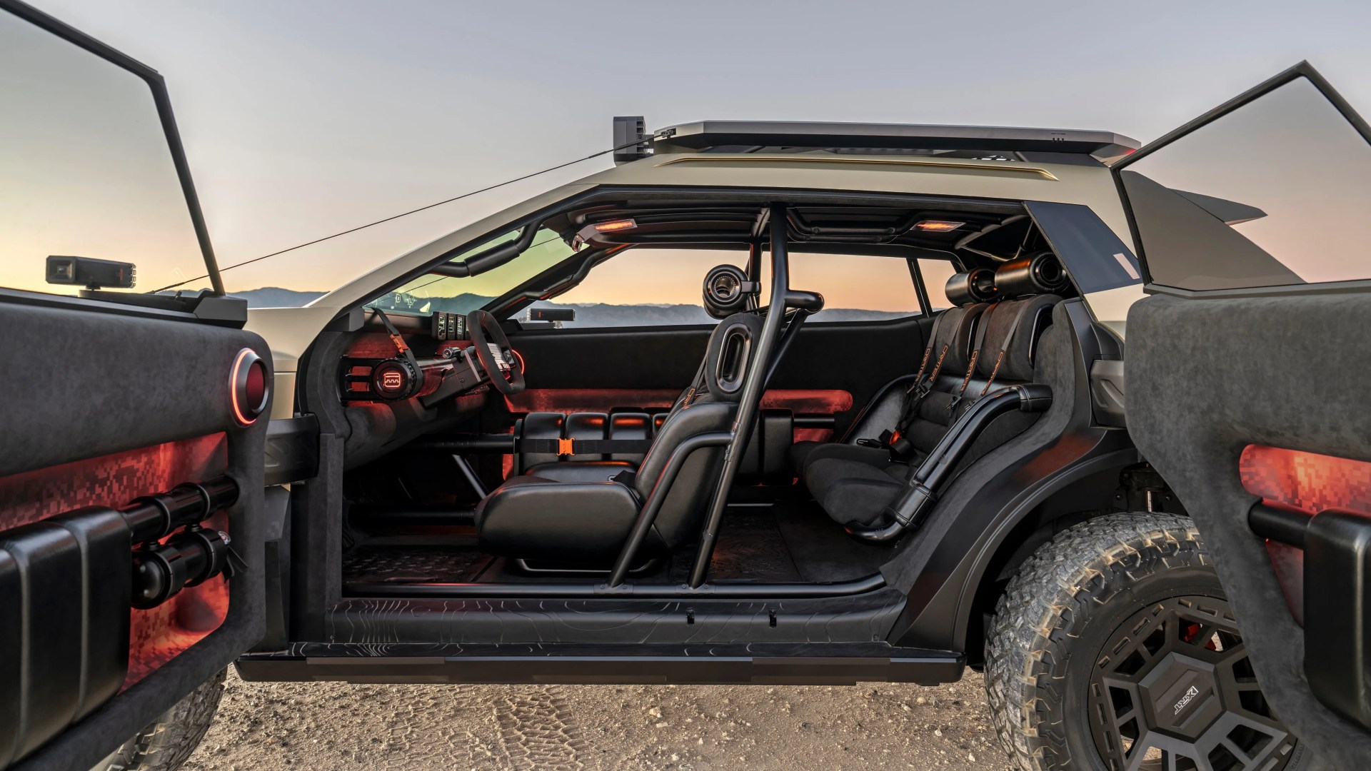 Side view of a rugged off-road vehicle interior with open doors, black seats, roll cage, and red ambient lighting.