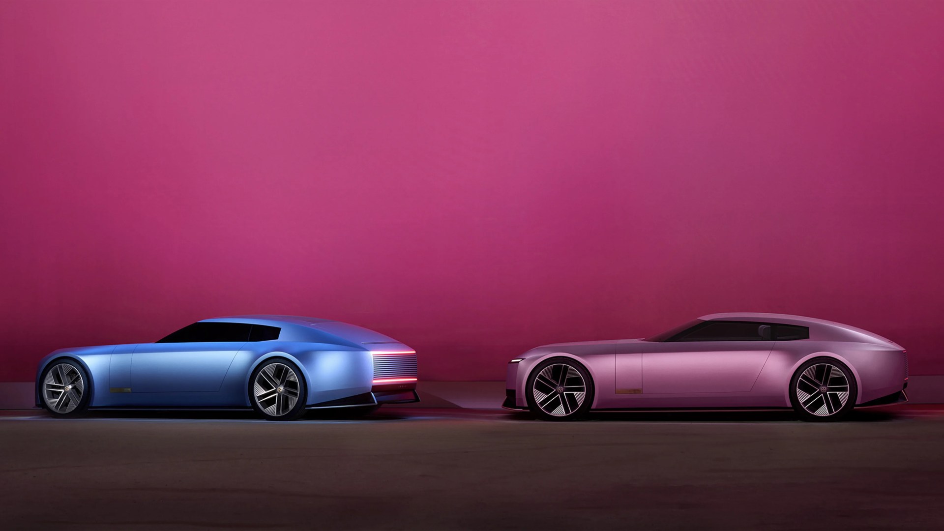 Two sleek, futuristic electric cars, one blue and one pink, parked side by side against a magenta wall.
