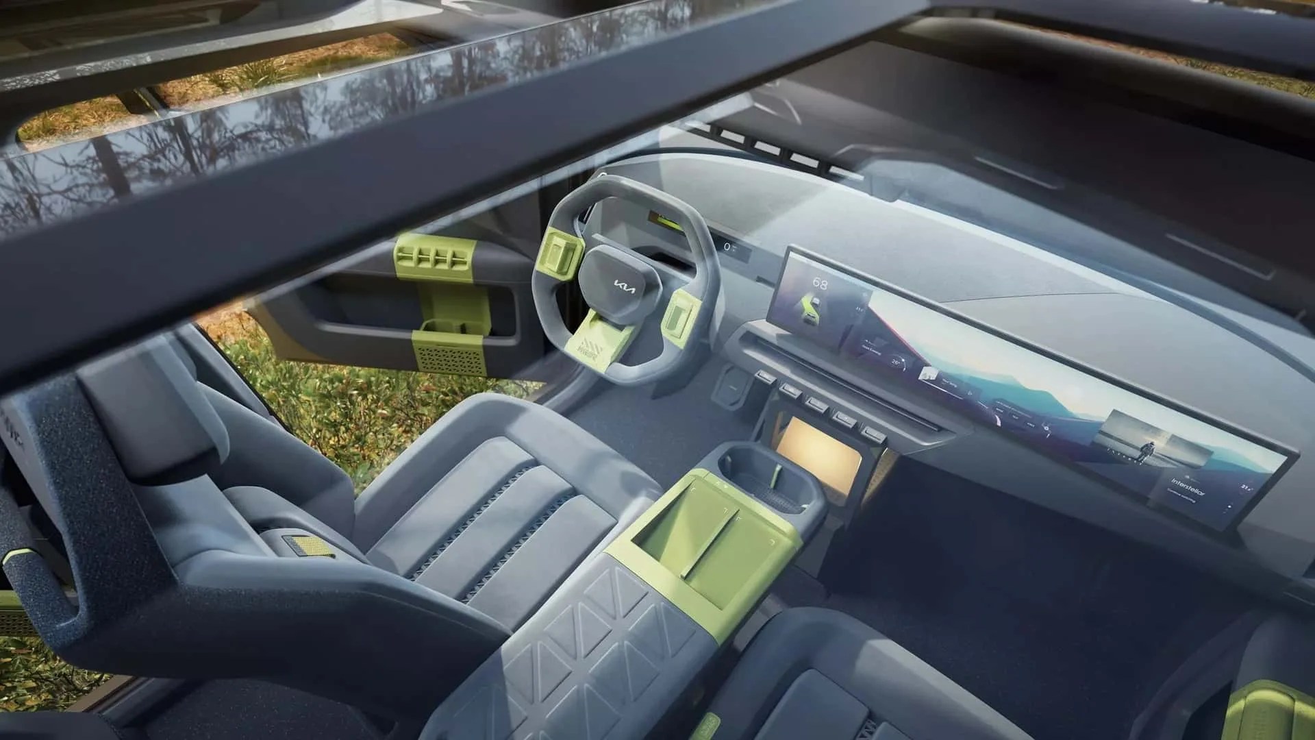 Car interior with gray seats, green accents on steering wheel, door, and center console, and dual widescreen digital displays.