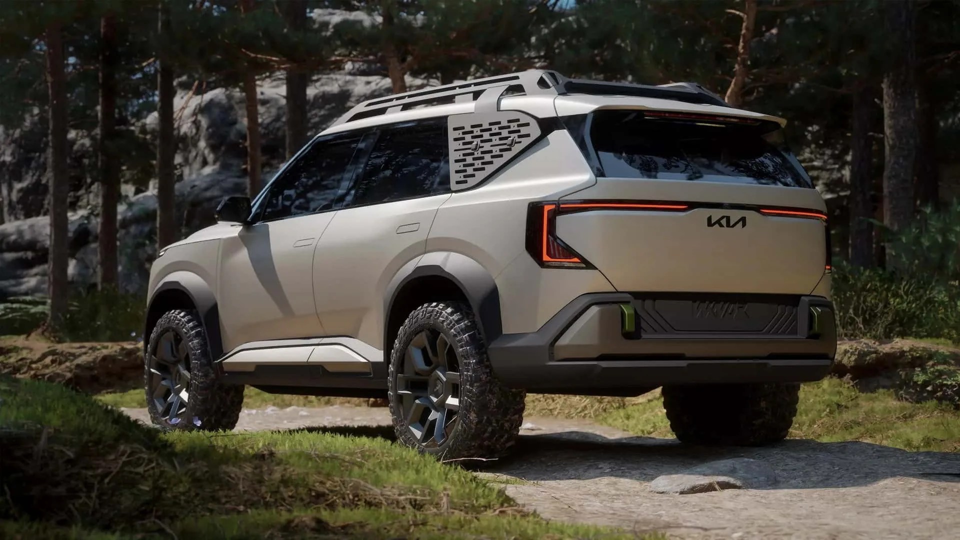 Beige Kia SUV with black trim and off-road tires parked on a rocky forest path.