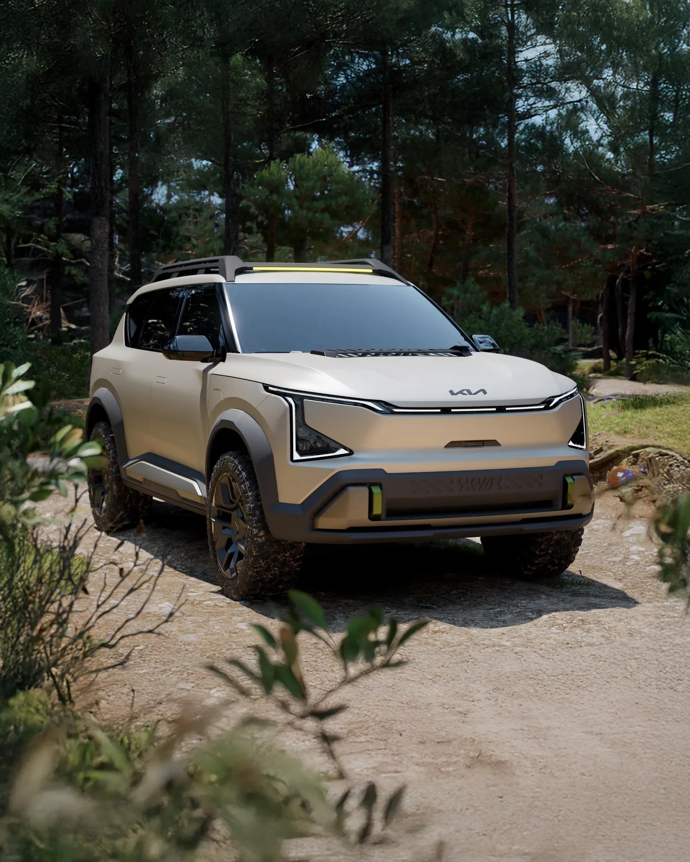 Beige Kia electric SUV with black trim and roof rack parked on a dirt path in a forest.