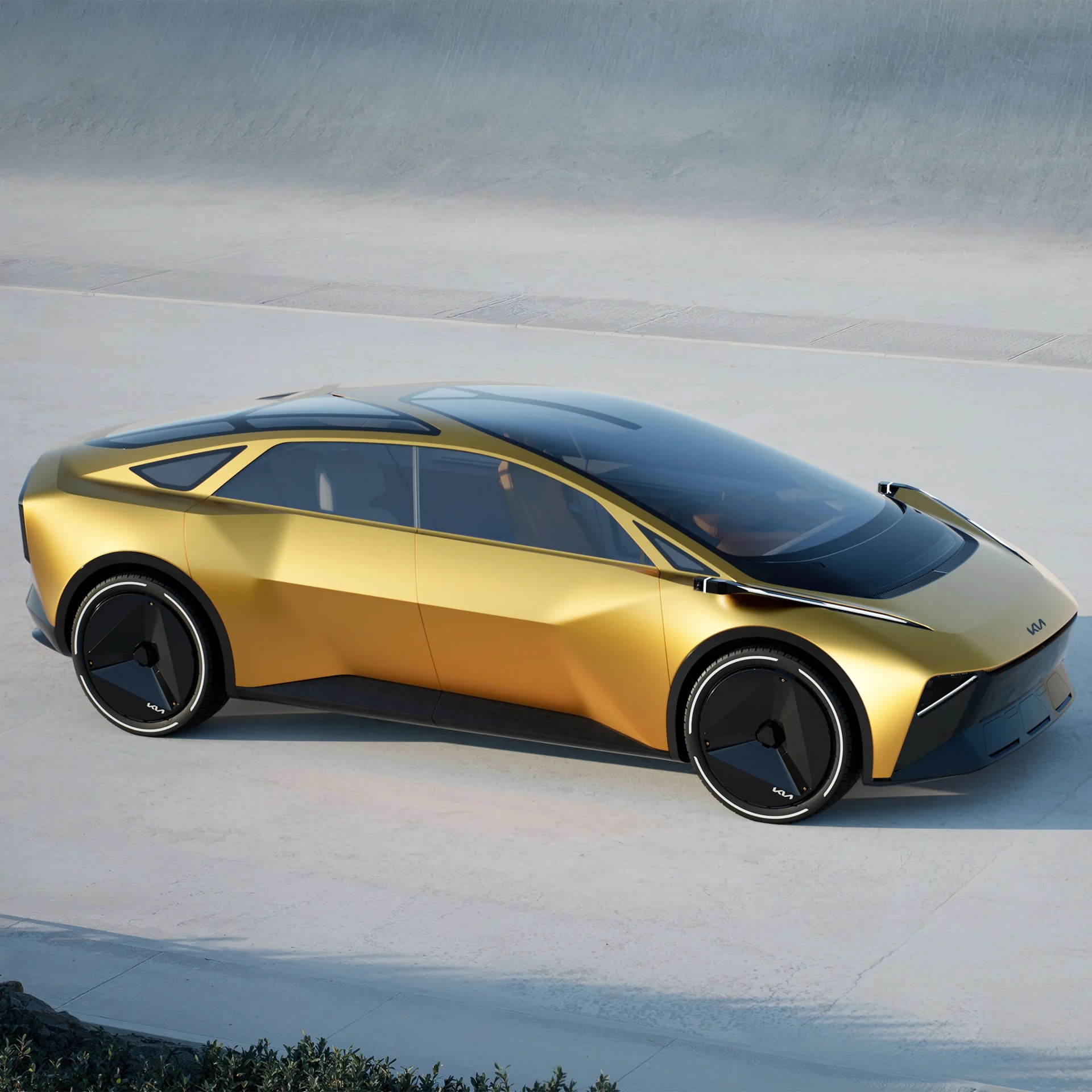 Sleek gold electric car with black aerodynamic wheels and large tinted windows on a concrete surface.
