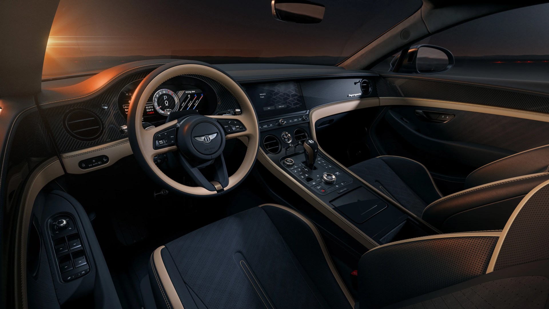 Luxury car interior with black and beige leather seats, beige-trimmed steering wheel, and carbon fiber dashboard at sunset.