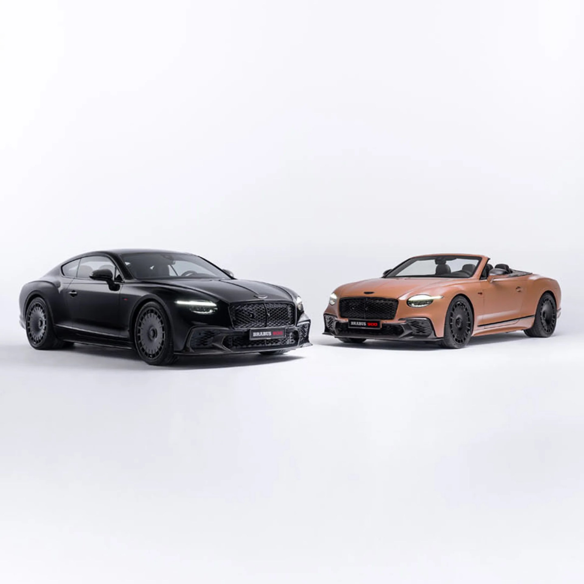 Two luxury sports cars, one black coupe and one bronze convertible, both with black wheels on a white background.