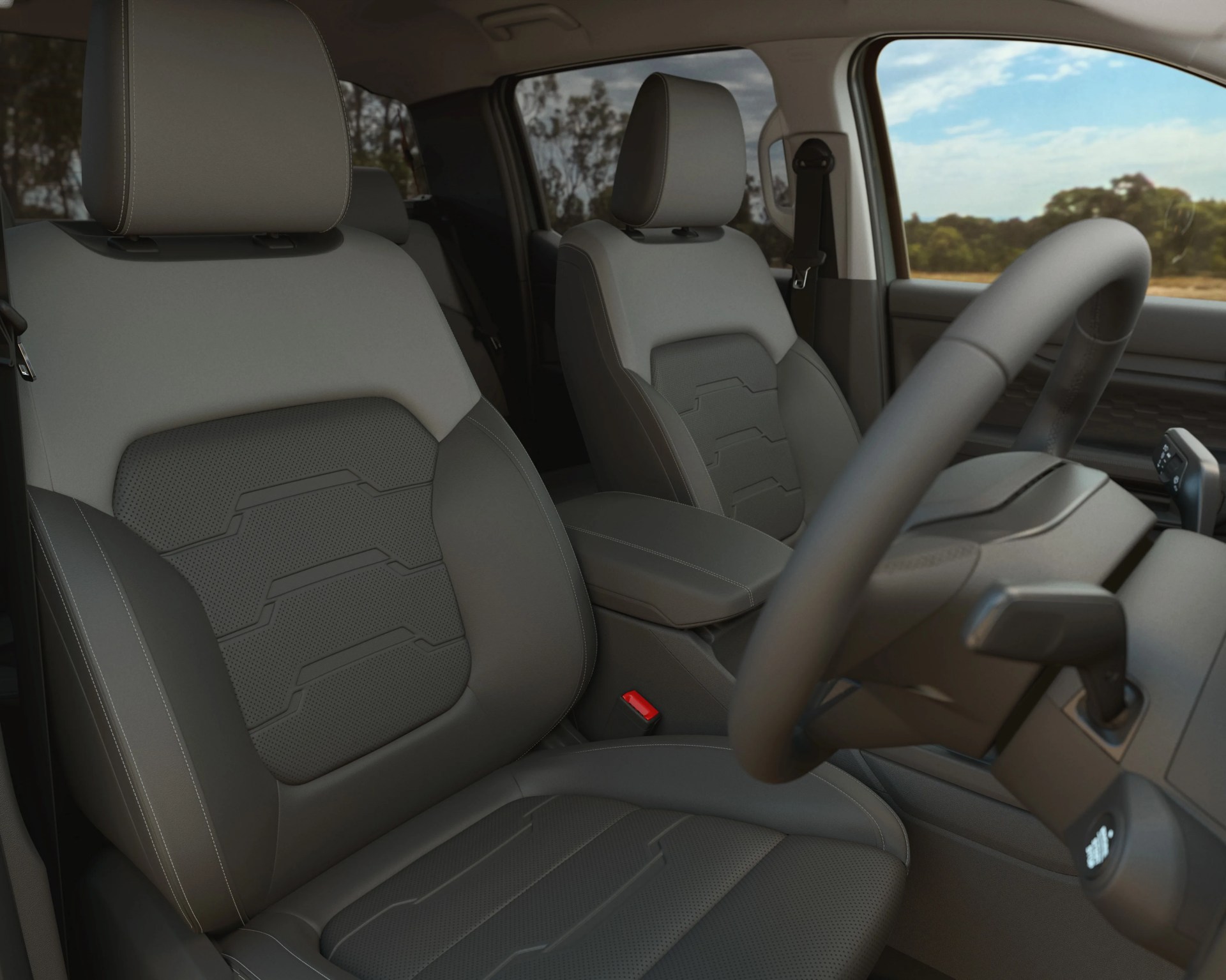 Two-tone gray leather car seats with perforated and patterned inserts inside a vehicle cabin.