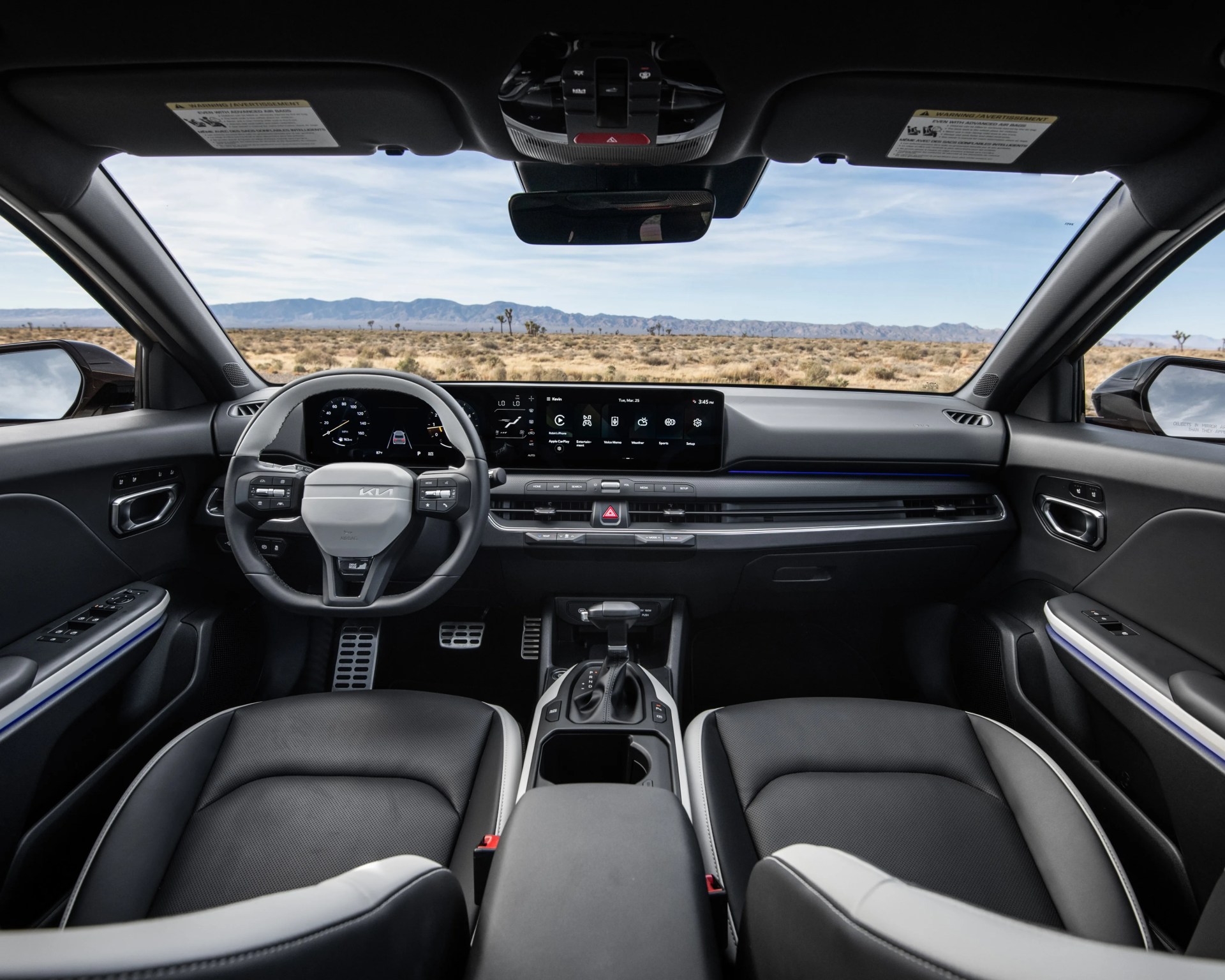 Interior of a modern car with black and gray leather seats, digital dashboard, and touchscreen display showing various controls.