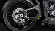 Close-up of a black motorcycle rear wheel with disc brake and swingarm featuring Reflexallen, D.I.D, and WD-40 logos.