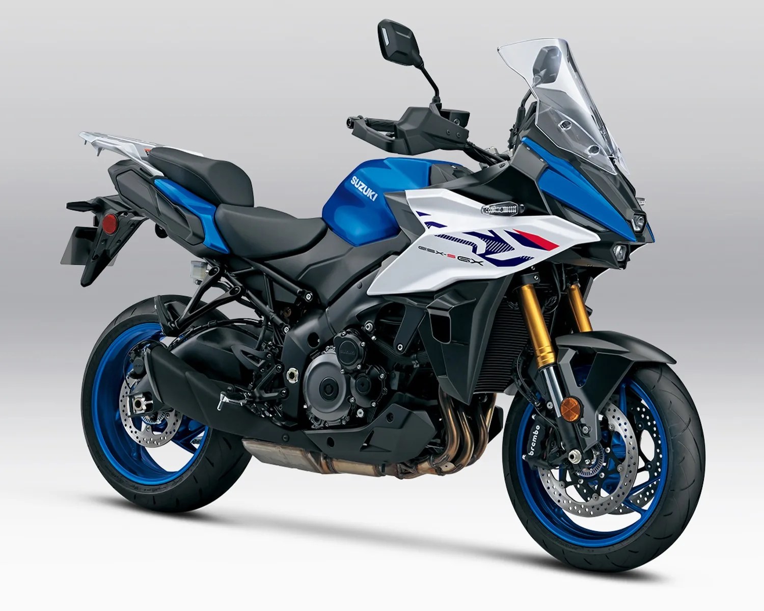 Blue, white, and black Suzuki GSX-S1000GT sport touring motorcycle with gold front forks and blue rims.