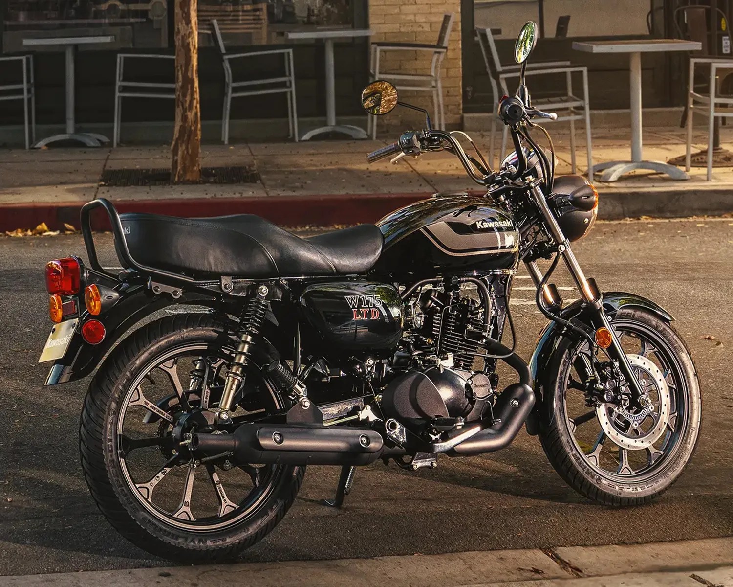 Black Kawasaki W175 LTD motorcycle parked on a street with chrome and matte black details.