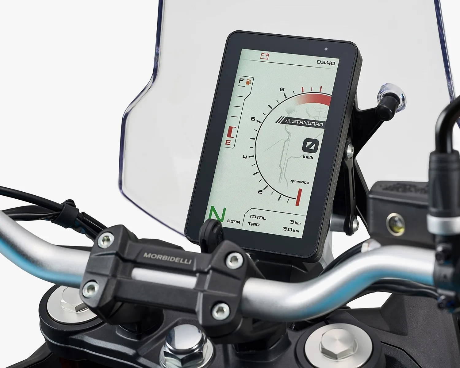 Motorcycle digital dashboard display showing speedometer, gear indicator, fuel gauge, and trip meter on handlebars.