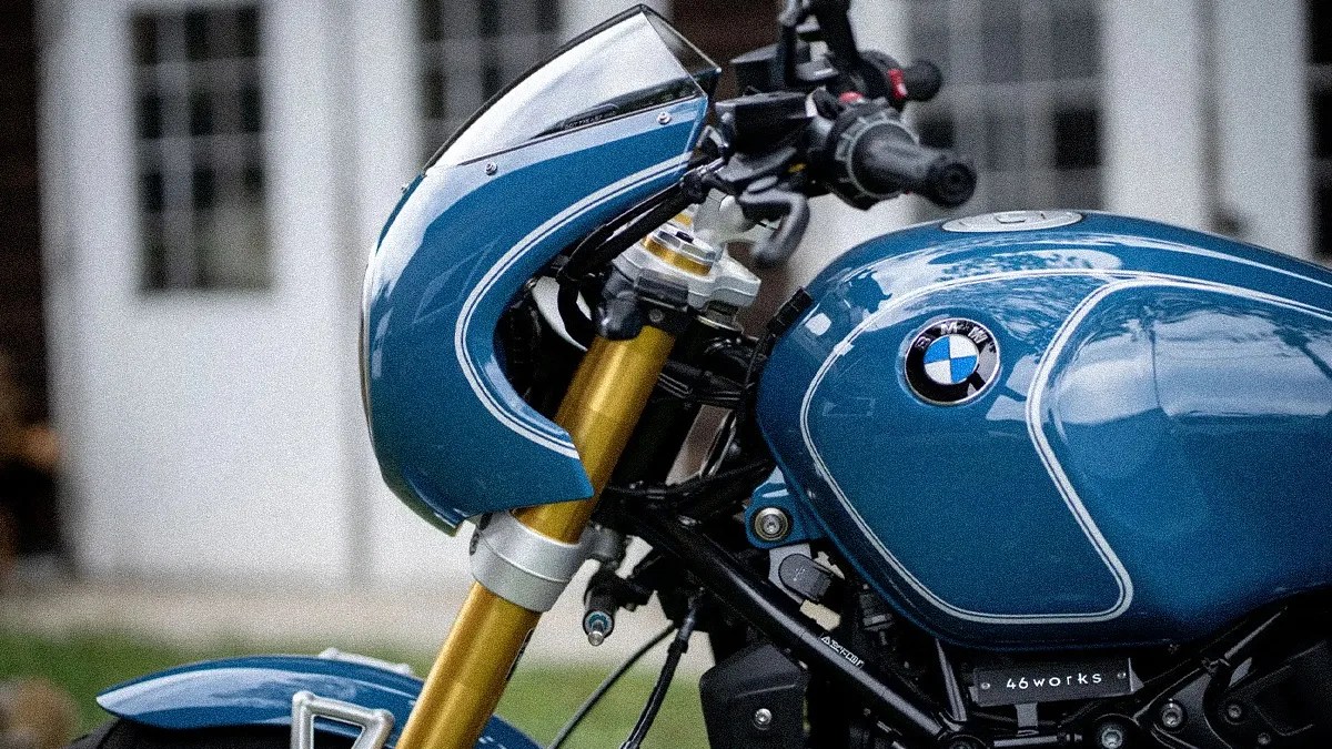 Blue BMW motorcycle fuel tank and front fairing with gold front suspension forks.