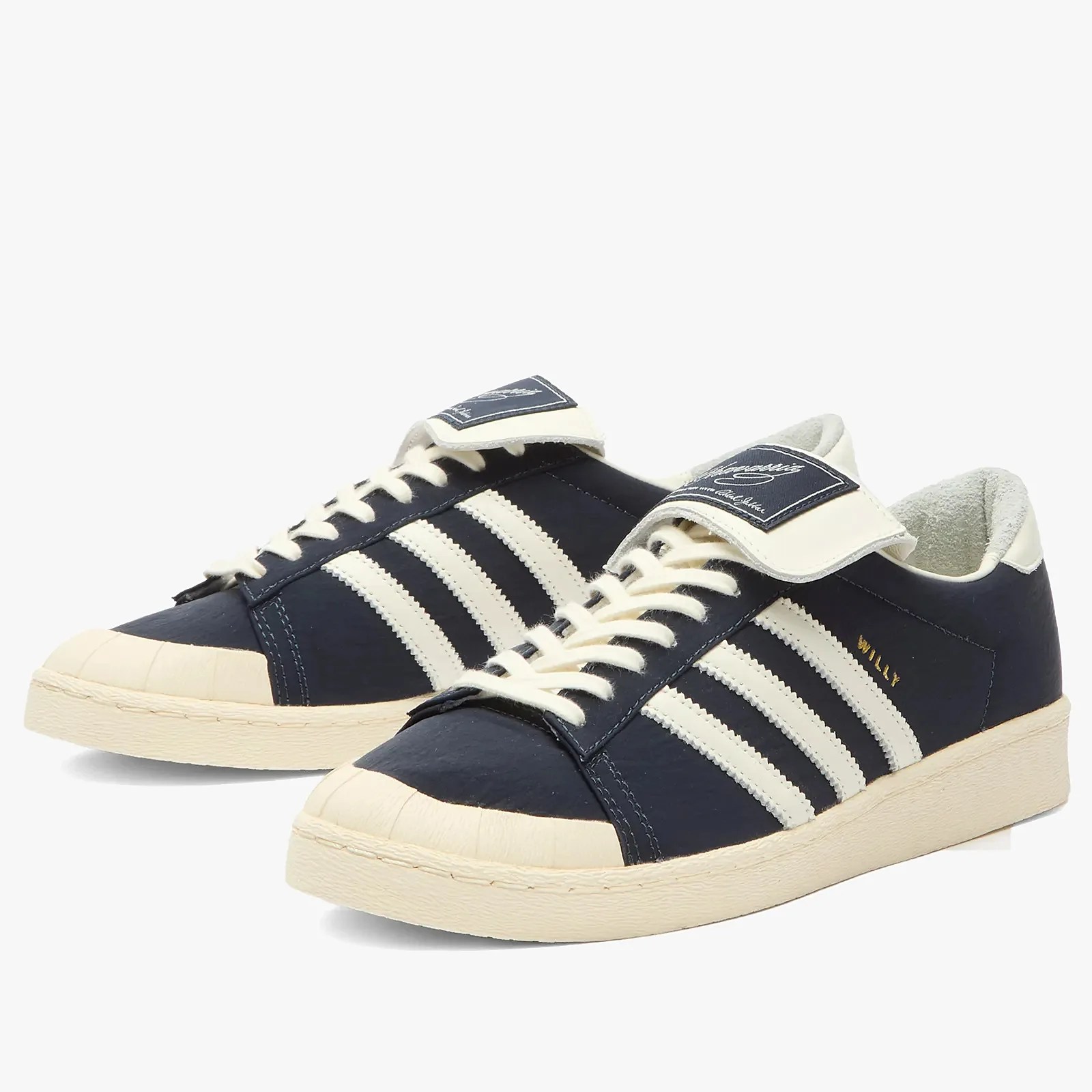 Pair of navy blue and off-white sneakers with three white stripes and off-white soles.