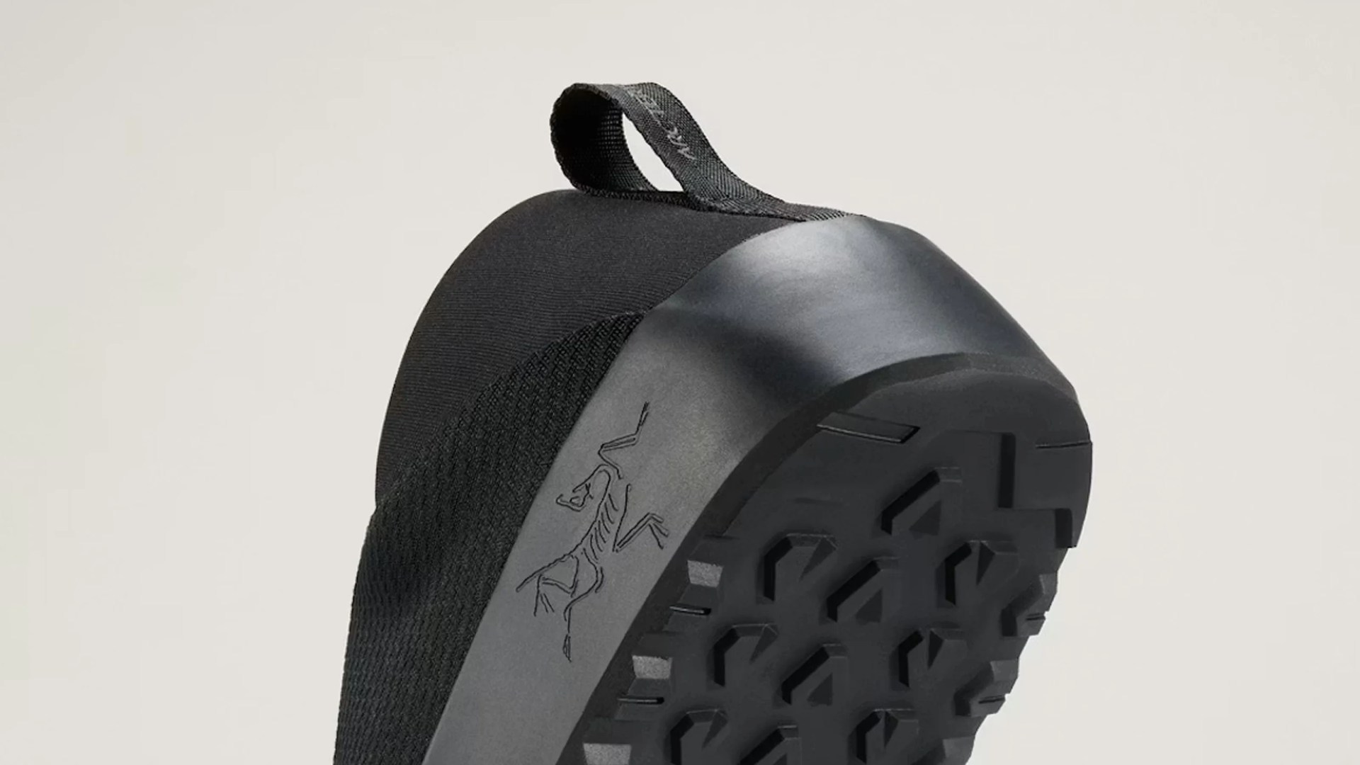Black climbing shoe with textured rubber sole and a pull tab at the heel.