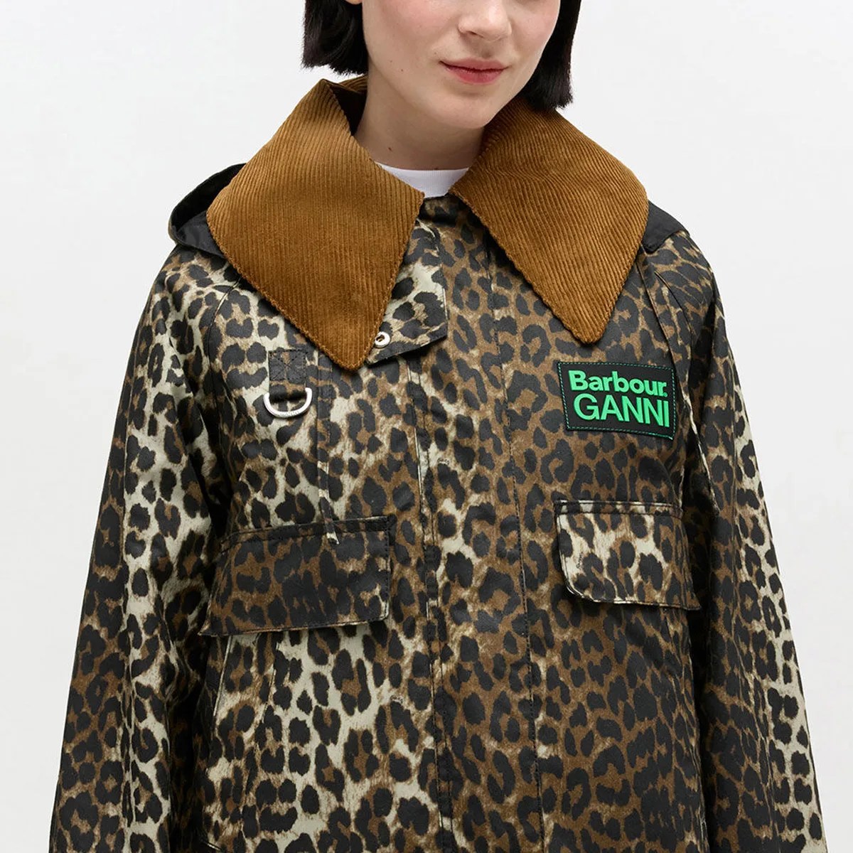 Leopard print jacket with large brown corduroy collar and green Barbour GANNI logo patch on chest.