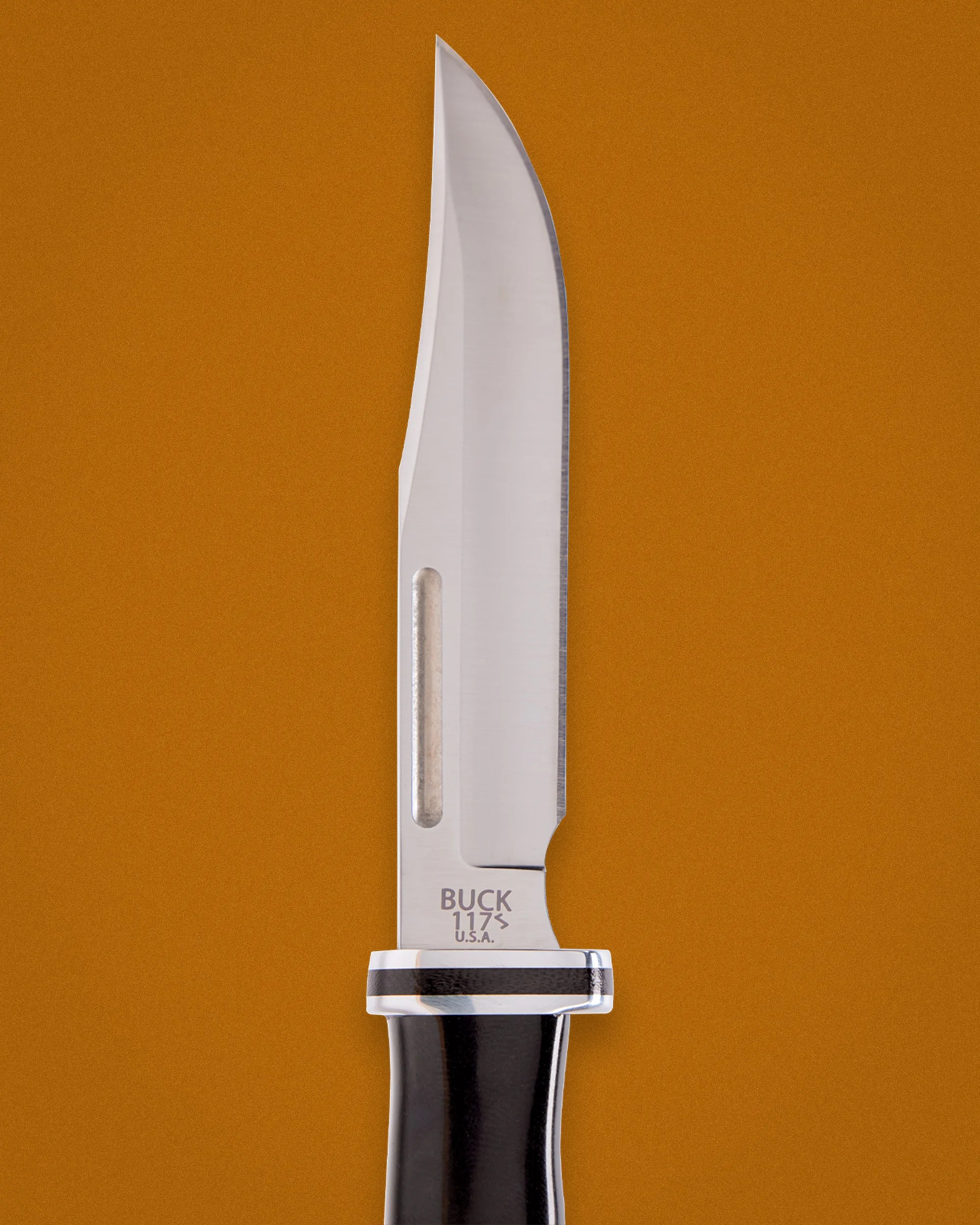 Buck 117S fixed blade knife with polished steel blade and black handle on an orange background.