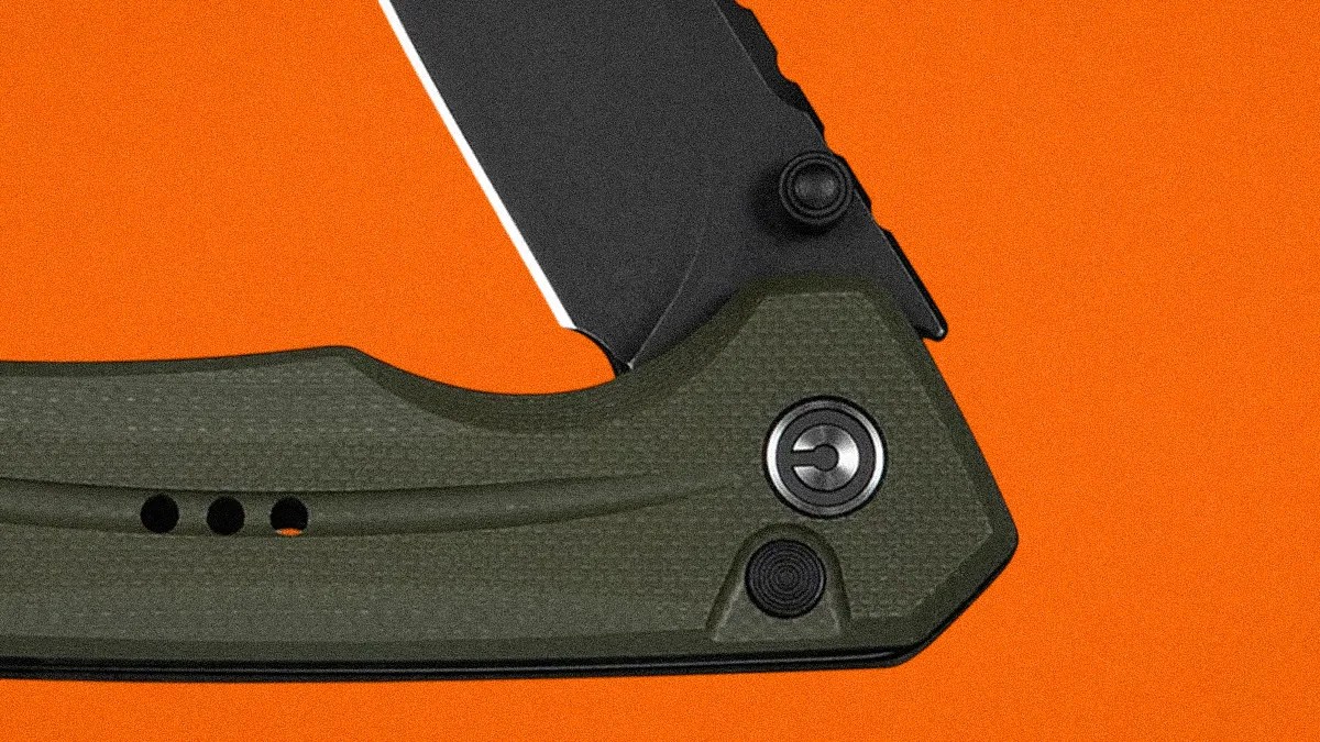 Close-up of a folding knife with a black blade and textured olive green handle on an orange background.