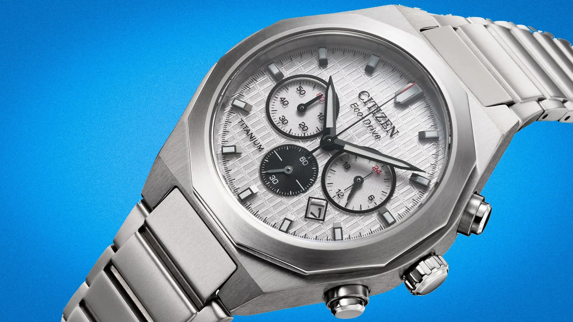 Silver Citizen Eco-Drive titanium chronograph watch with white textured dial and metal bracelet on blue background.
