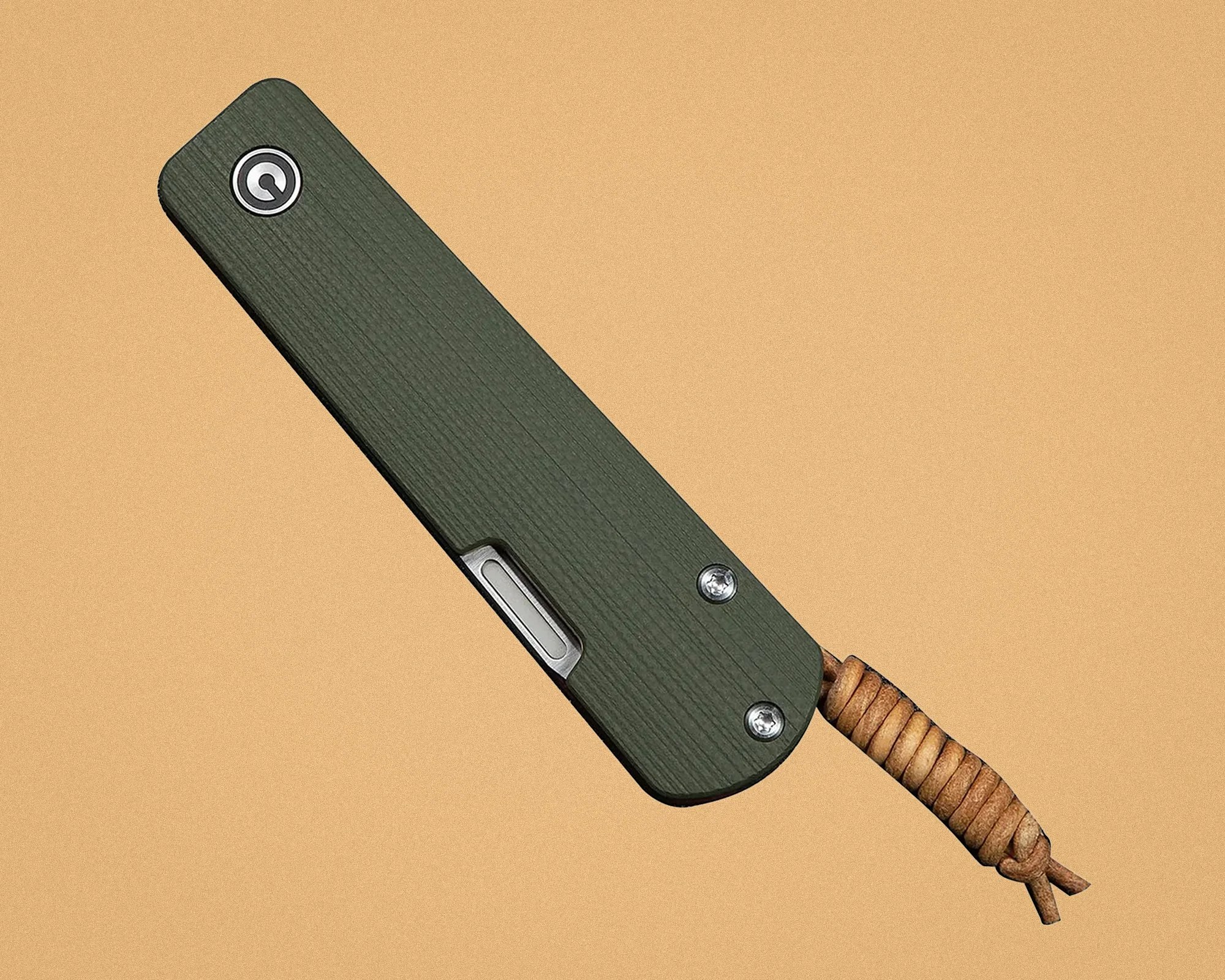 Green textured folding knife with metal screws and a brown leather lanyard on a beige background.