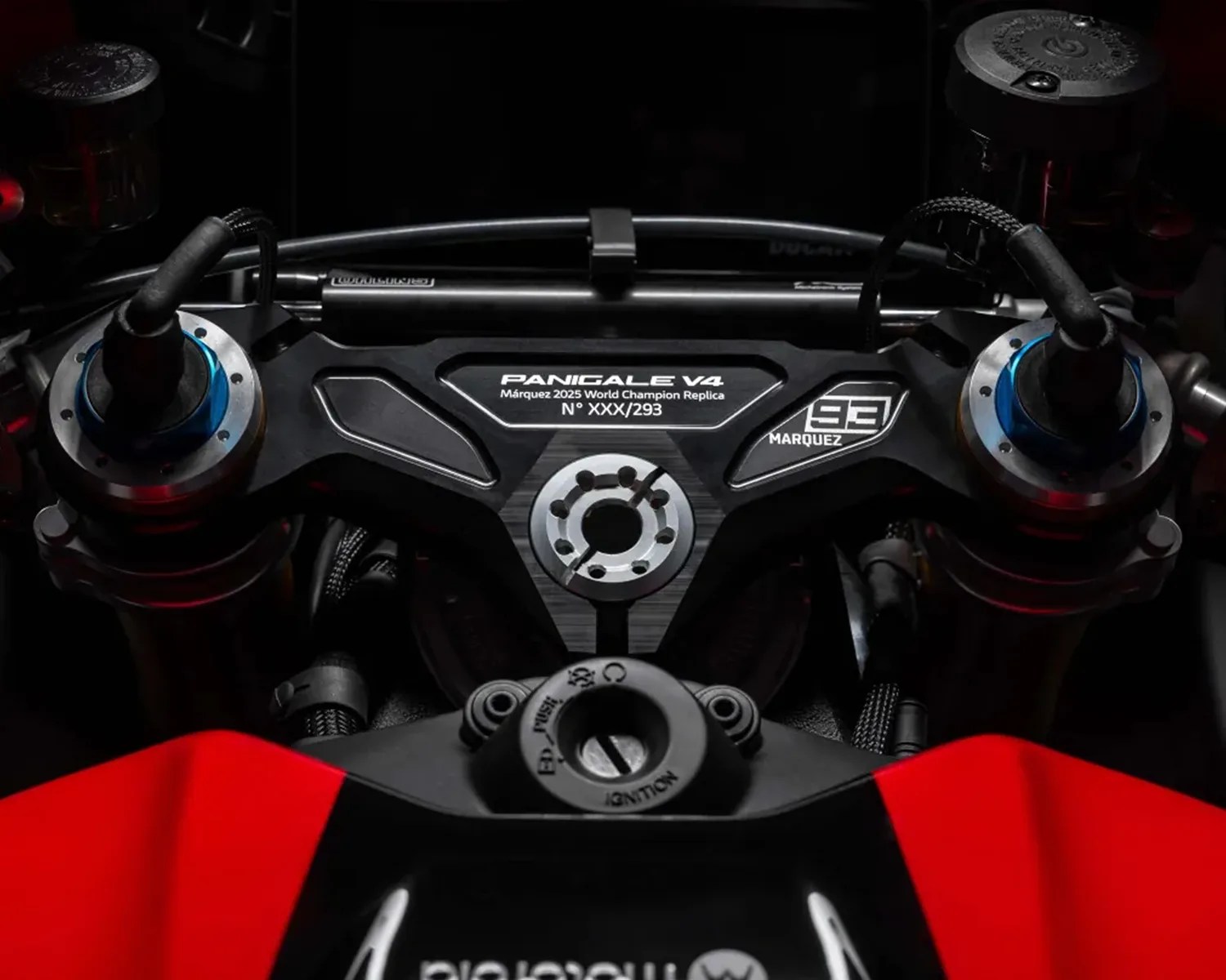 Close-up of a Ducati Panigale V4 motorcycle triple clamp with "Marquez 2025 World Champion Replica" and number 93 decals.